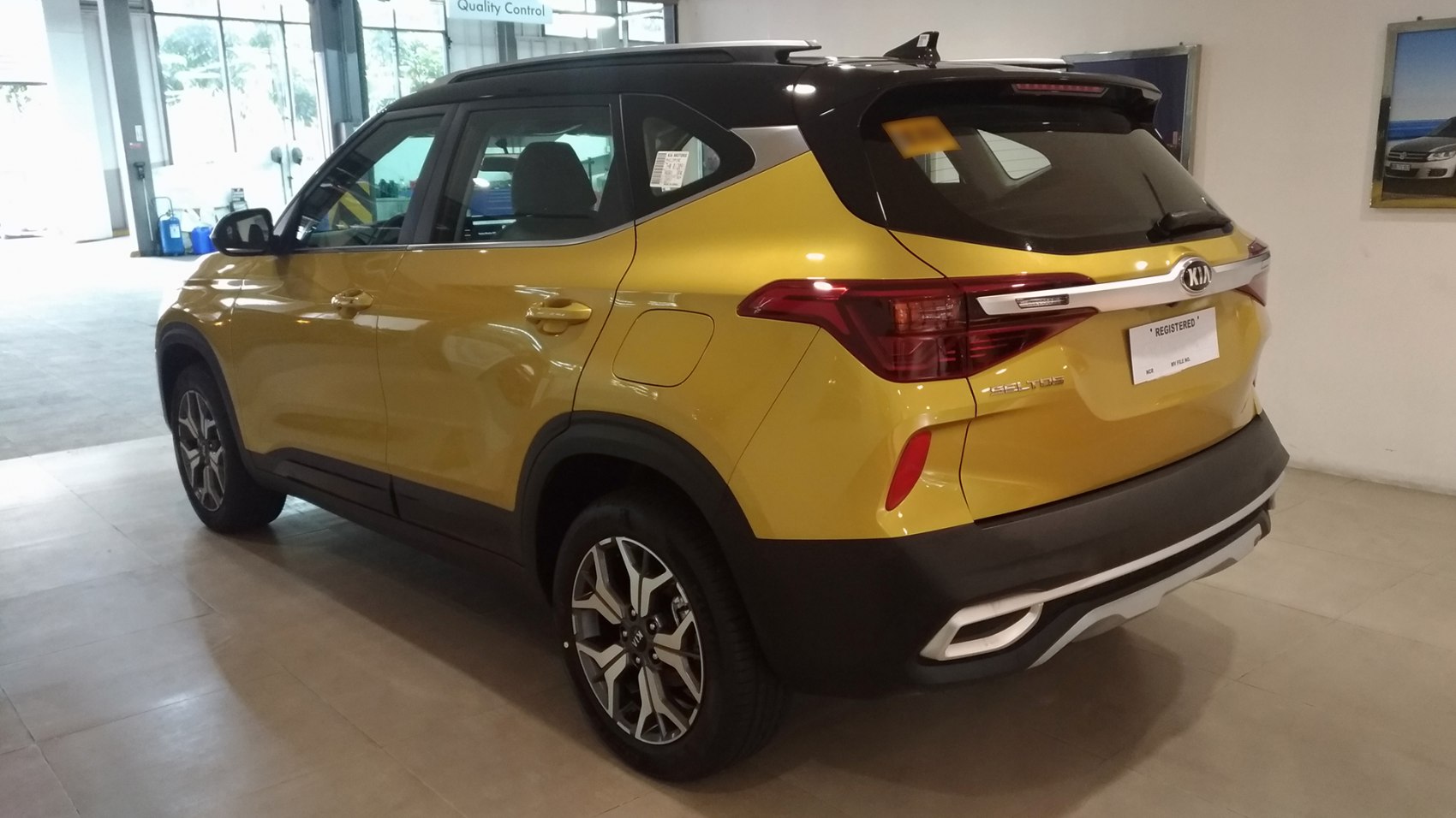 Yellow SUV rear side with black roof and alloy wheels