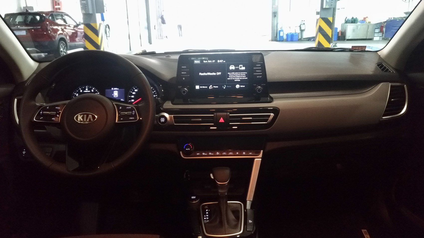 Car interior dashboard with infotainment screen and automatic transmission gear shift