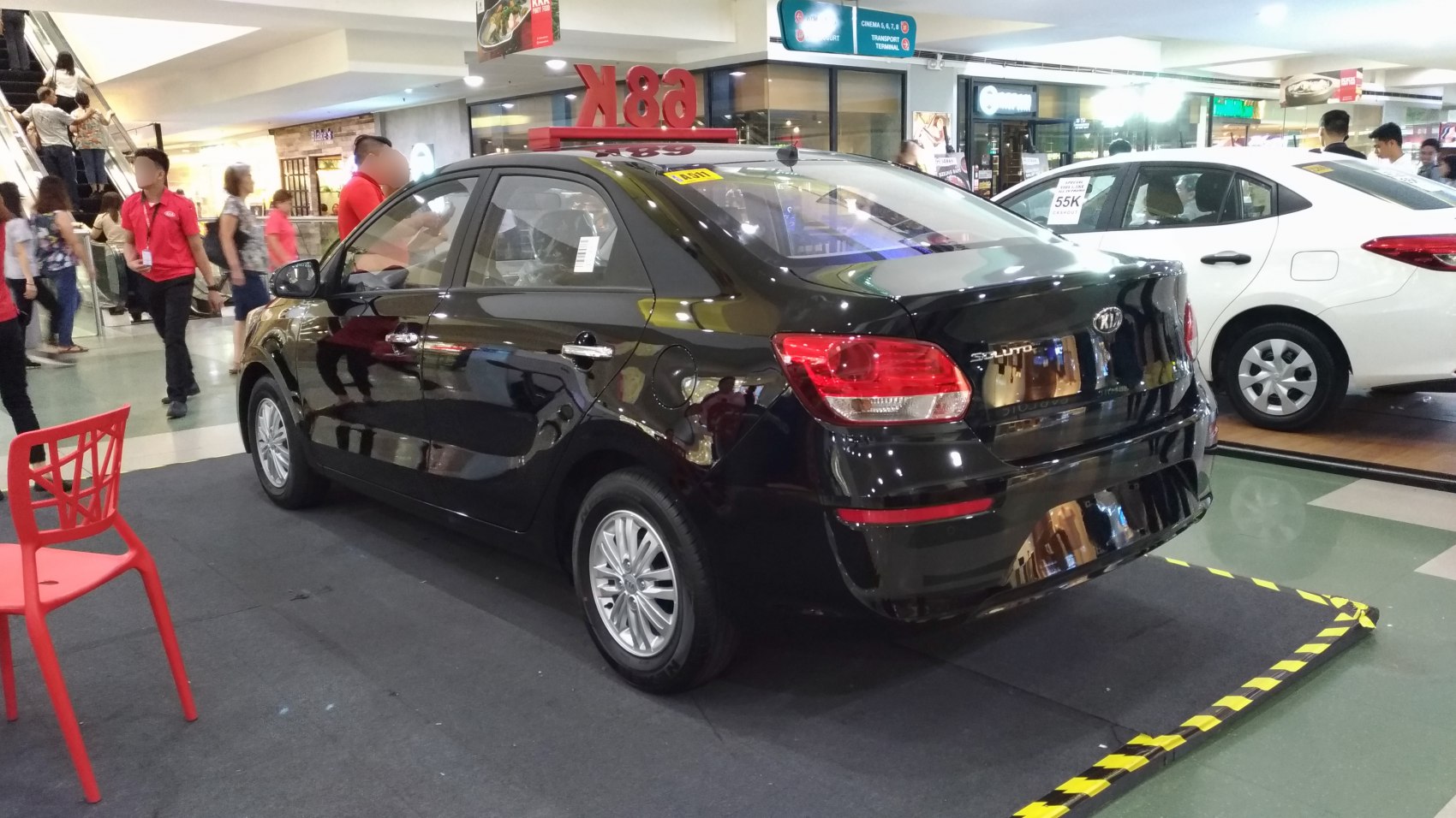 Black sedan rear and side view with alloy wheels and tail lights