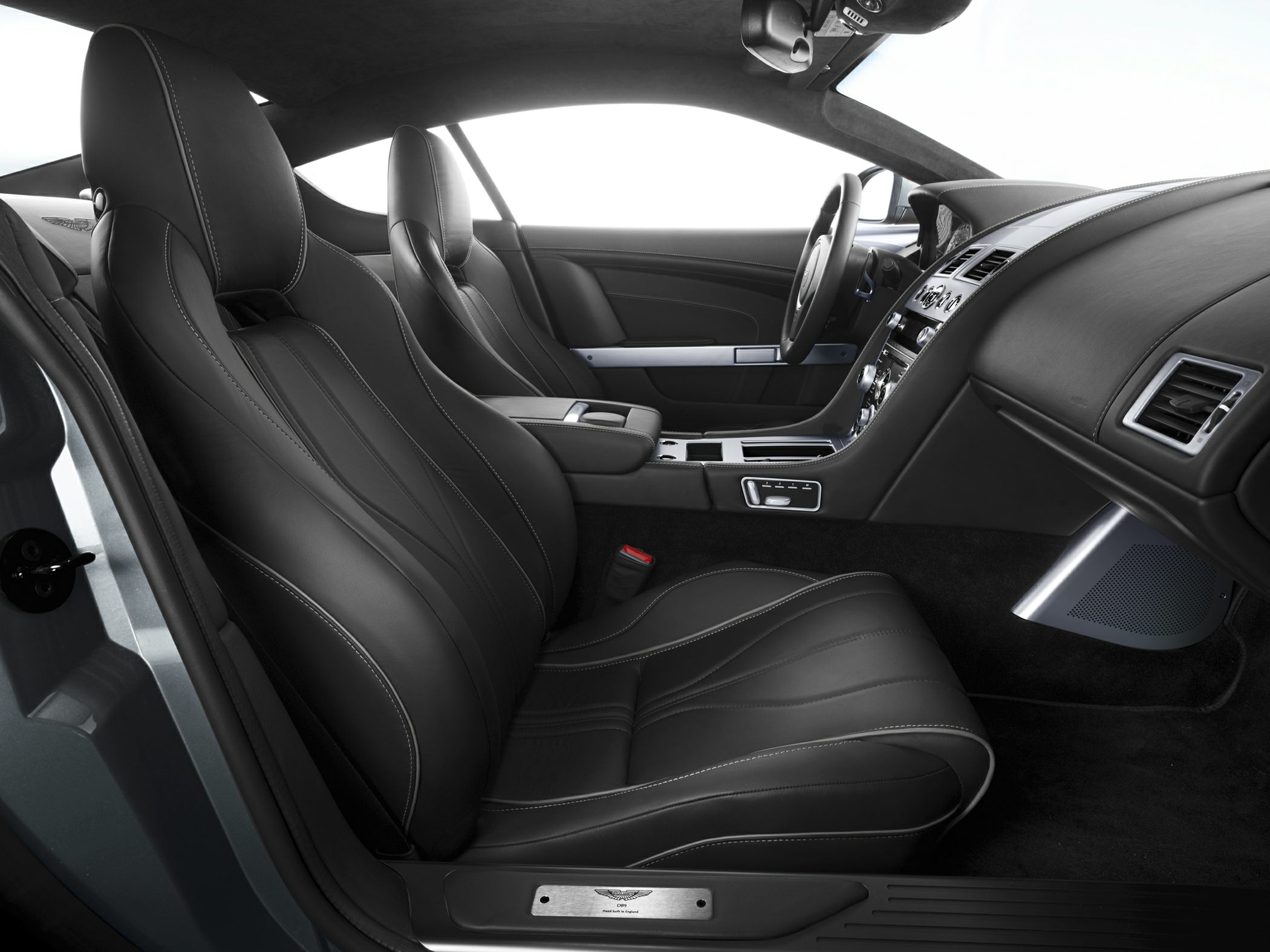 Black leather seats with silver stitching and modern dashboard design.