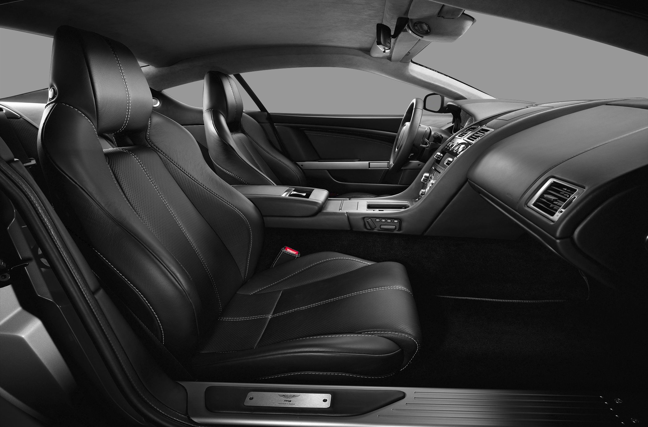 Black leather sport seats and sleek dashboard in luxury coupe interior