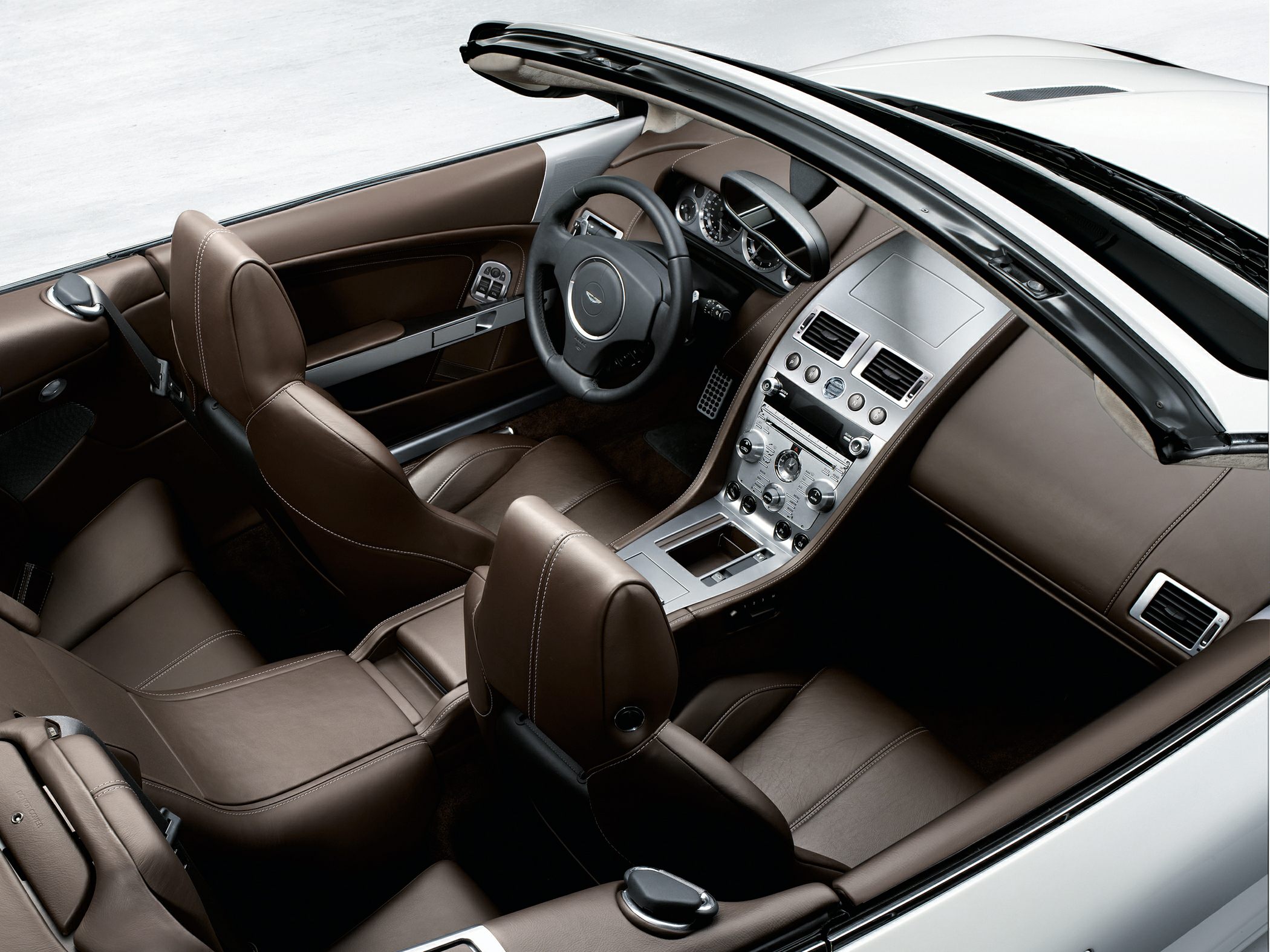 Convertible interior with brown leather seats and modern aluminum-accented dashboard