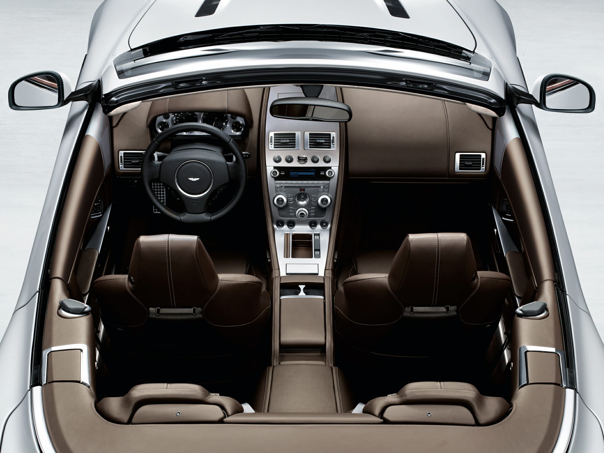 Luxury convertible interior with brown leather seats and modern dashboard controls
