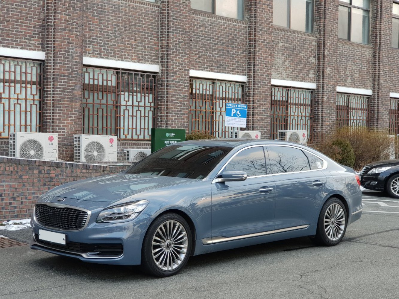 Blue luxury sedan with multi-spoke alloy wheels and tinted windows