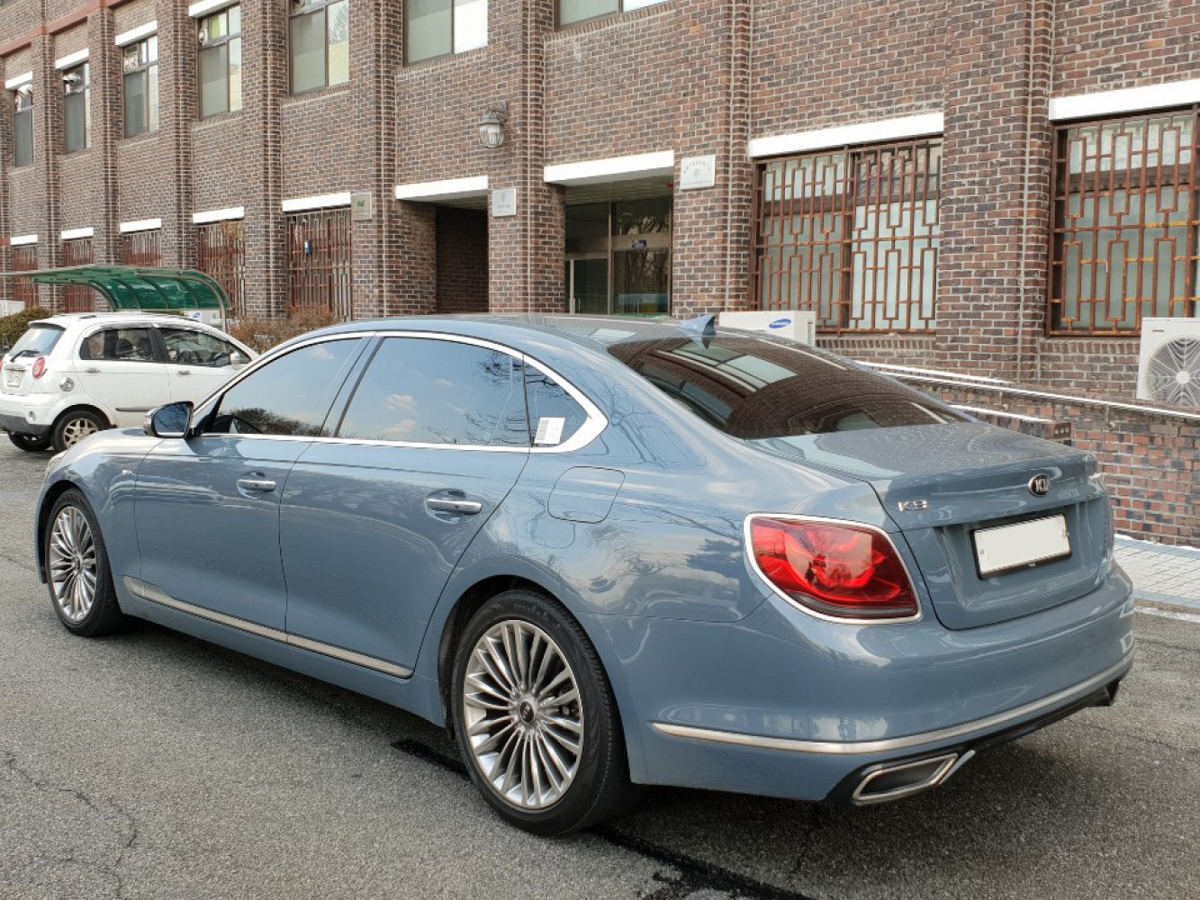 Rear and side profile of a luxury sedan with LED tail lights and alloy wheels