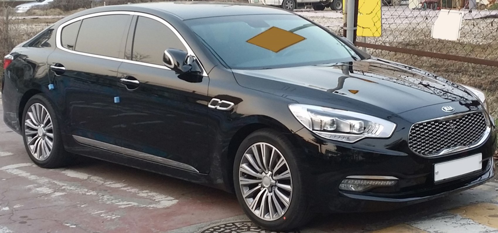Luxury sedan with distinctive front grill and LED headlights, tinted windows