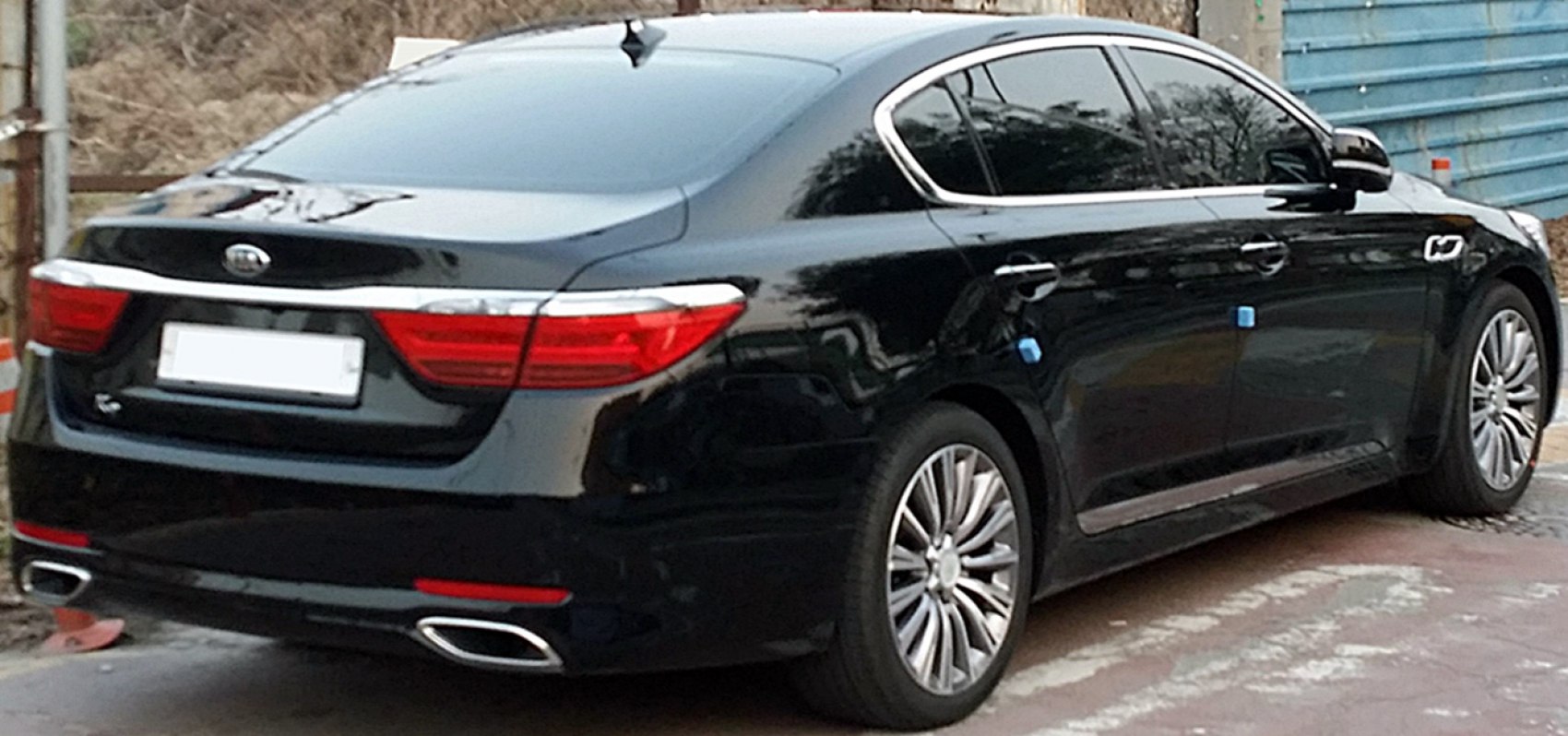 Rear view of luxury sedan with dual exhausts and distinctive tail lights