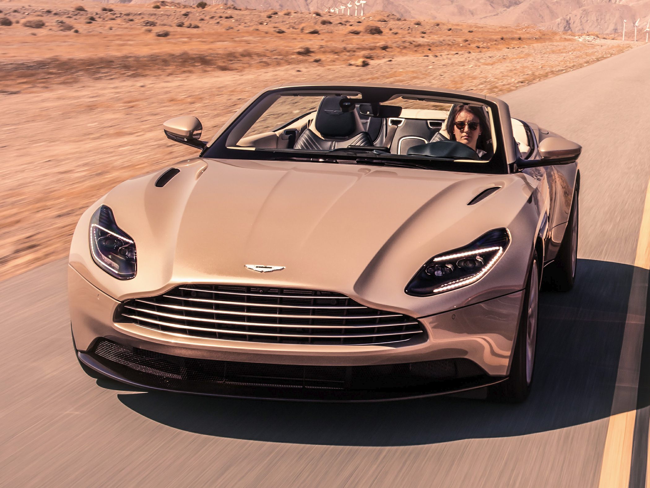 Front view of a luxury convertible with sleek headlights and grille
