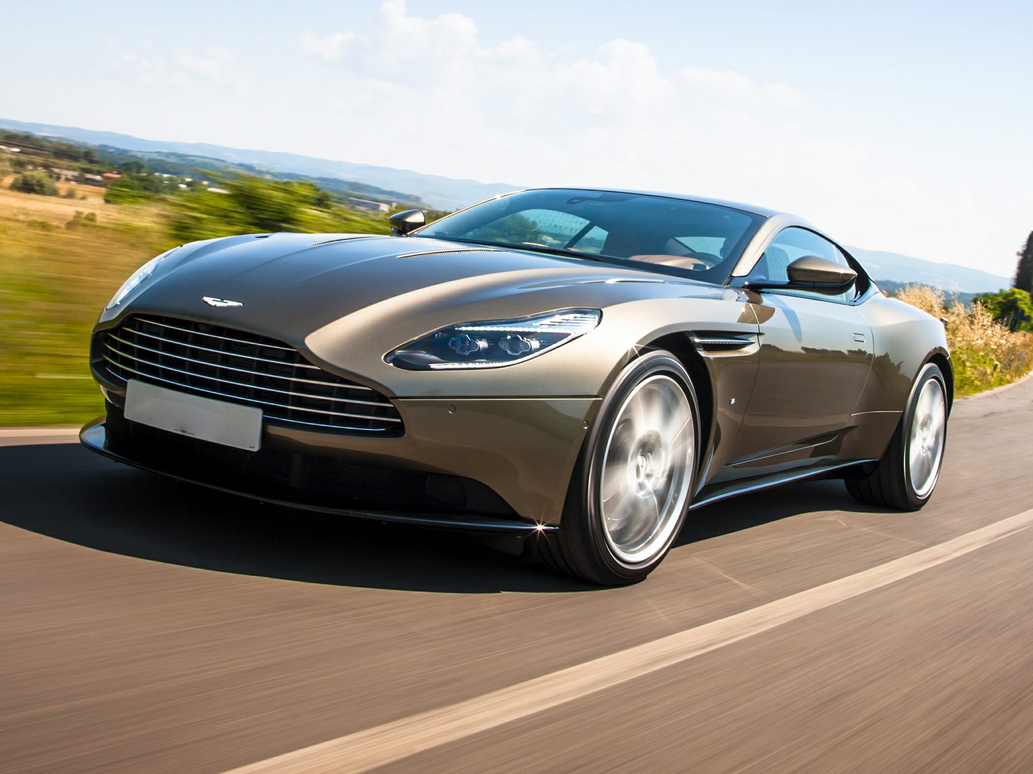 Front grille and sleek LED headlights of a luxury coupe in motion