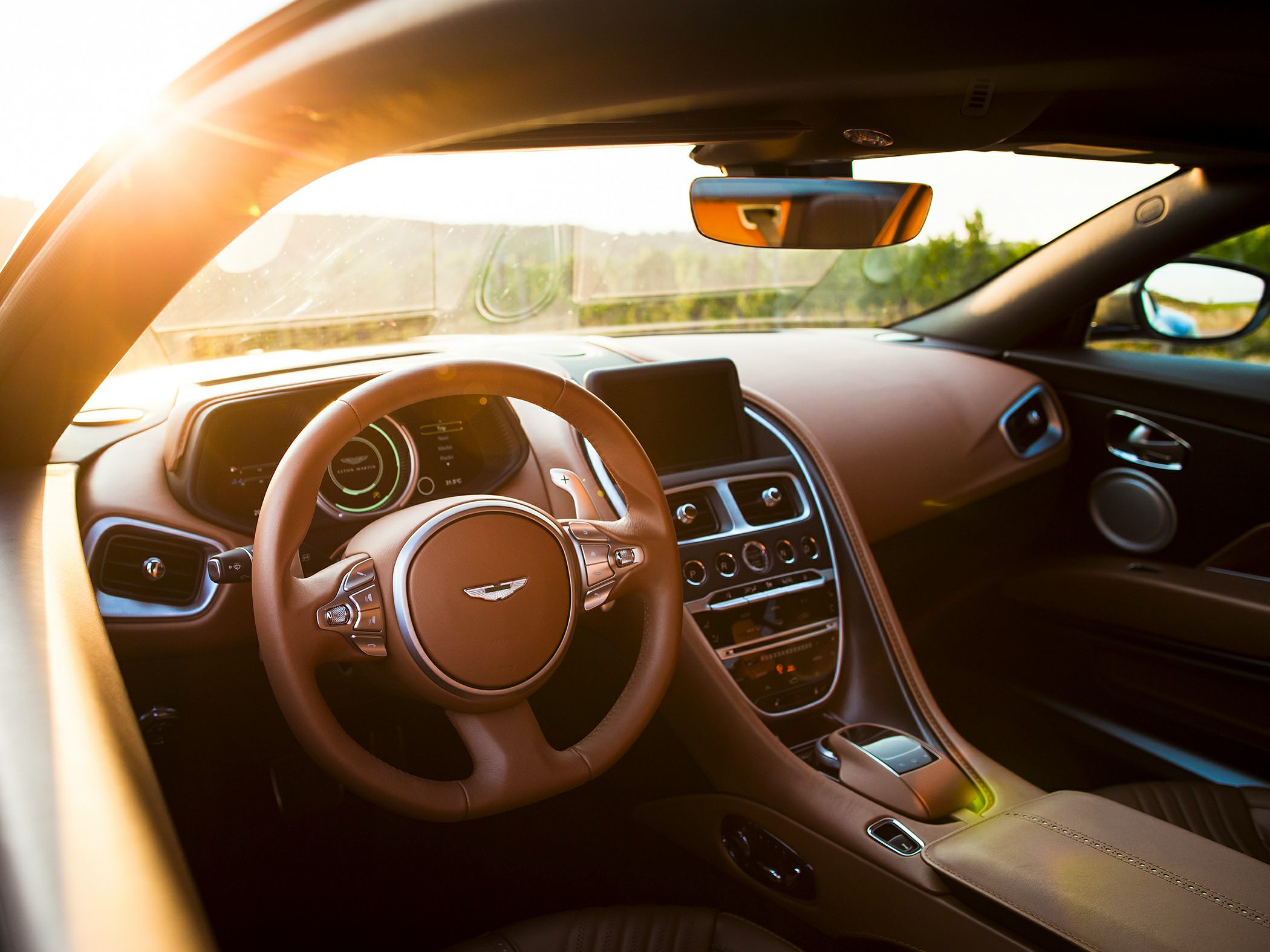 Tan leather interior with digital dashboard and multifunction steering wheel.