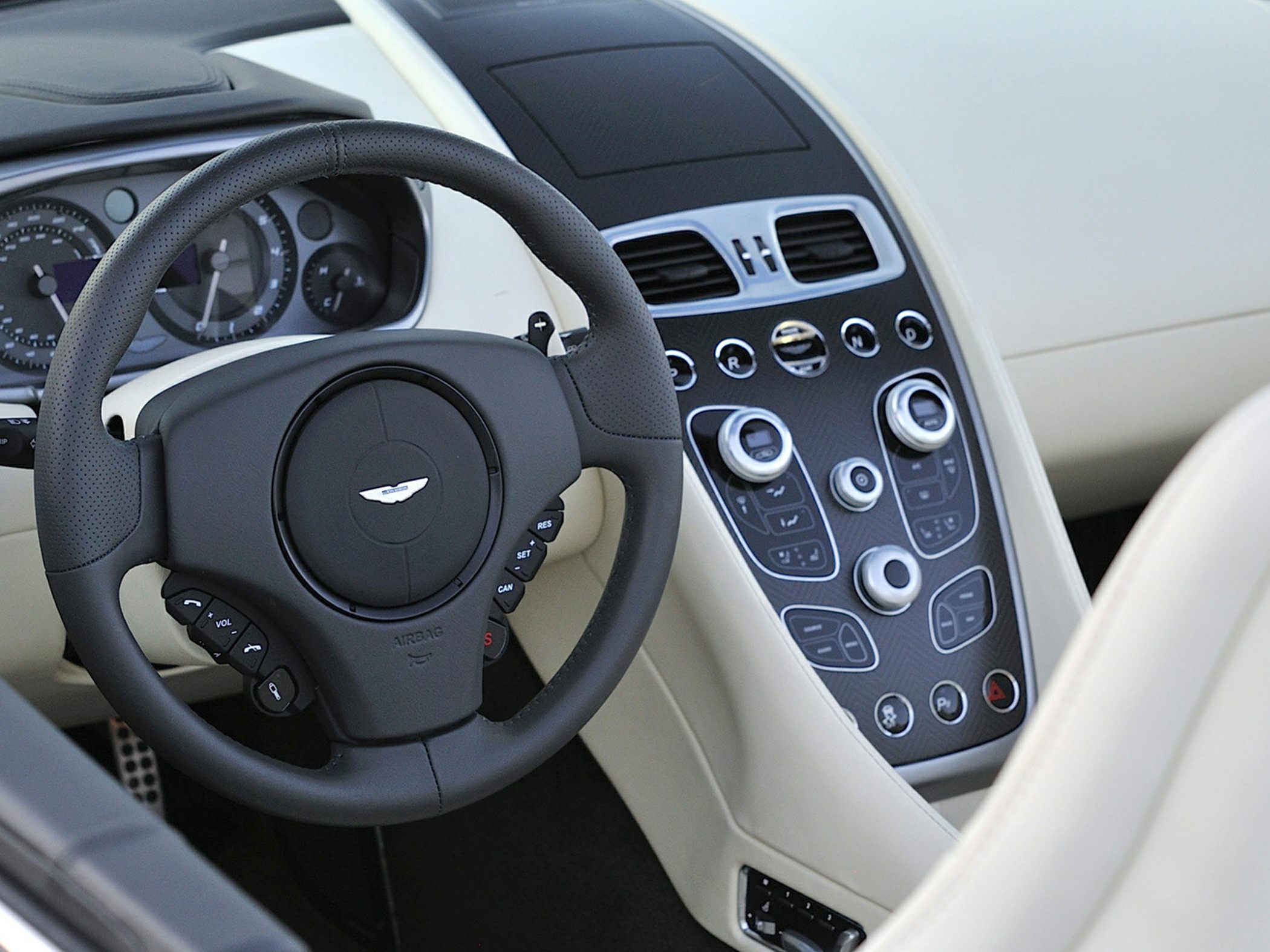 Steering wheel and center console controls with buttons and dials