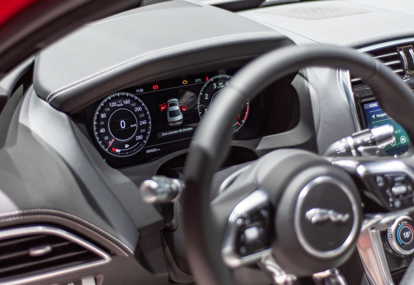 Digital instrument cluster and steering wheel of a luxury car interior