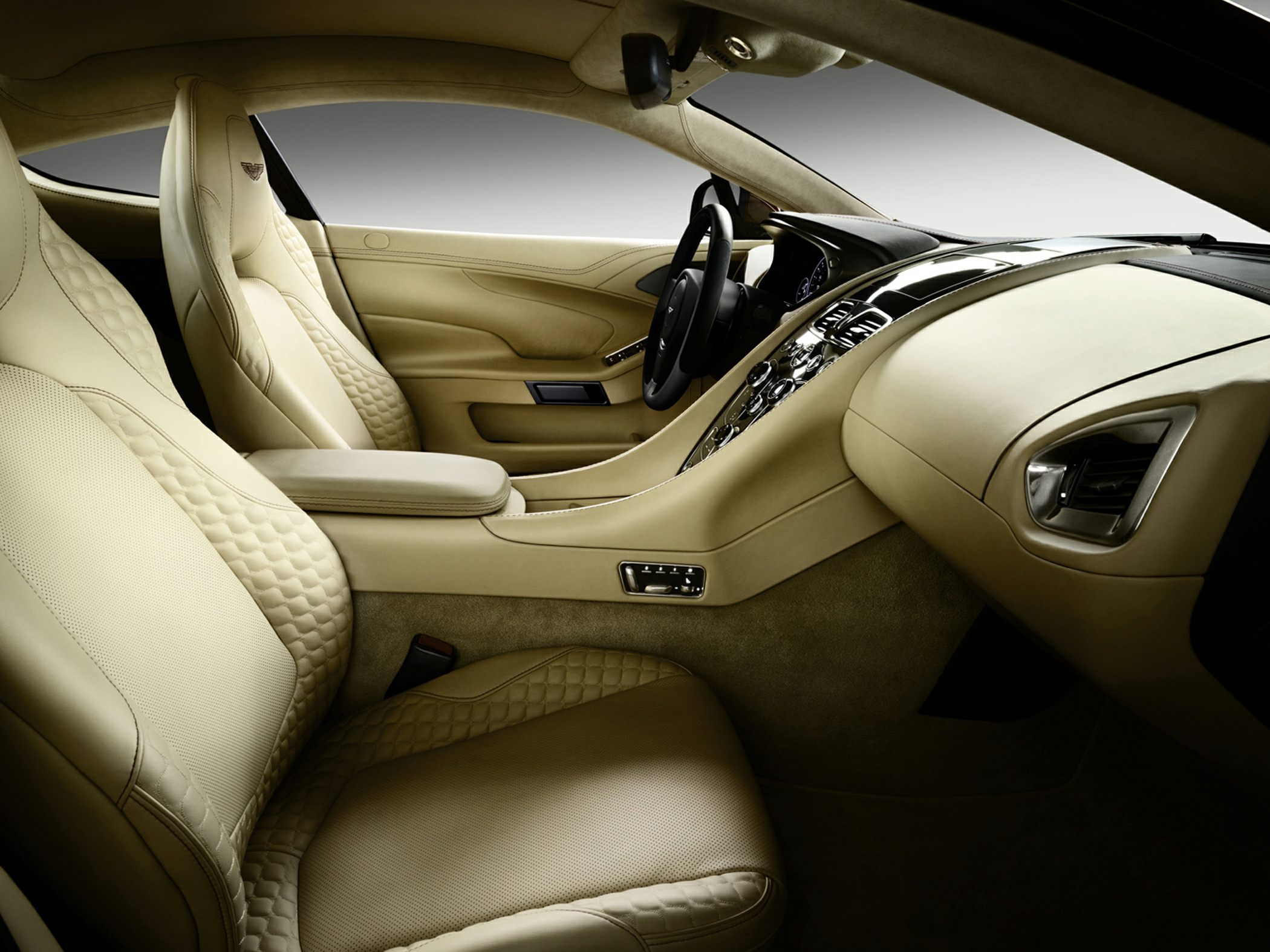 Beige leather seats with quilted pattern and sleek cockpit layout