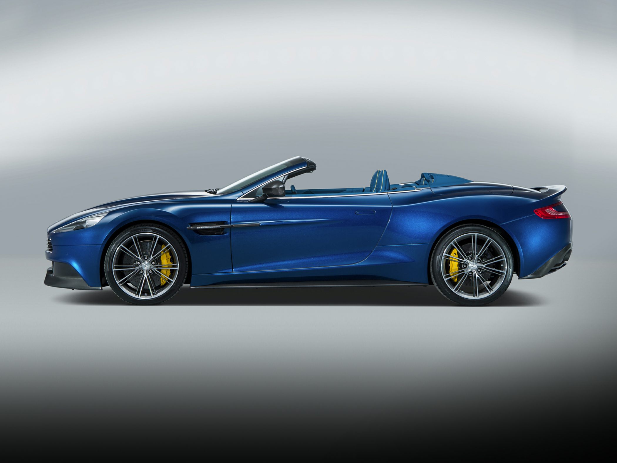 Convertible sports car side profile with yellow brake calipers