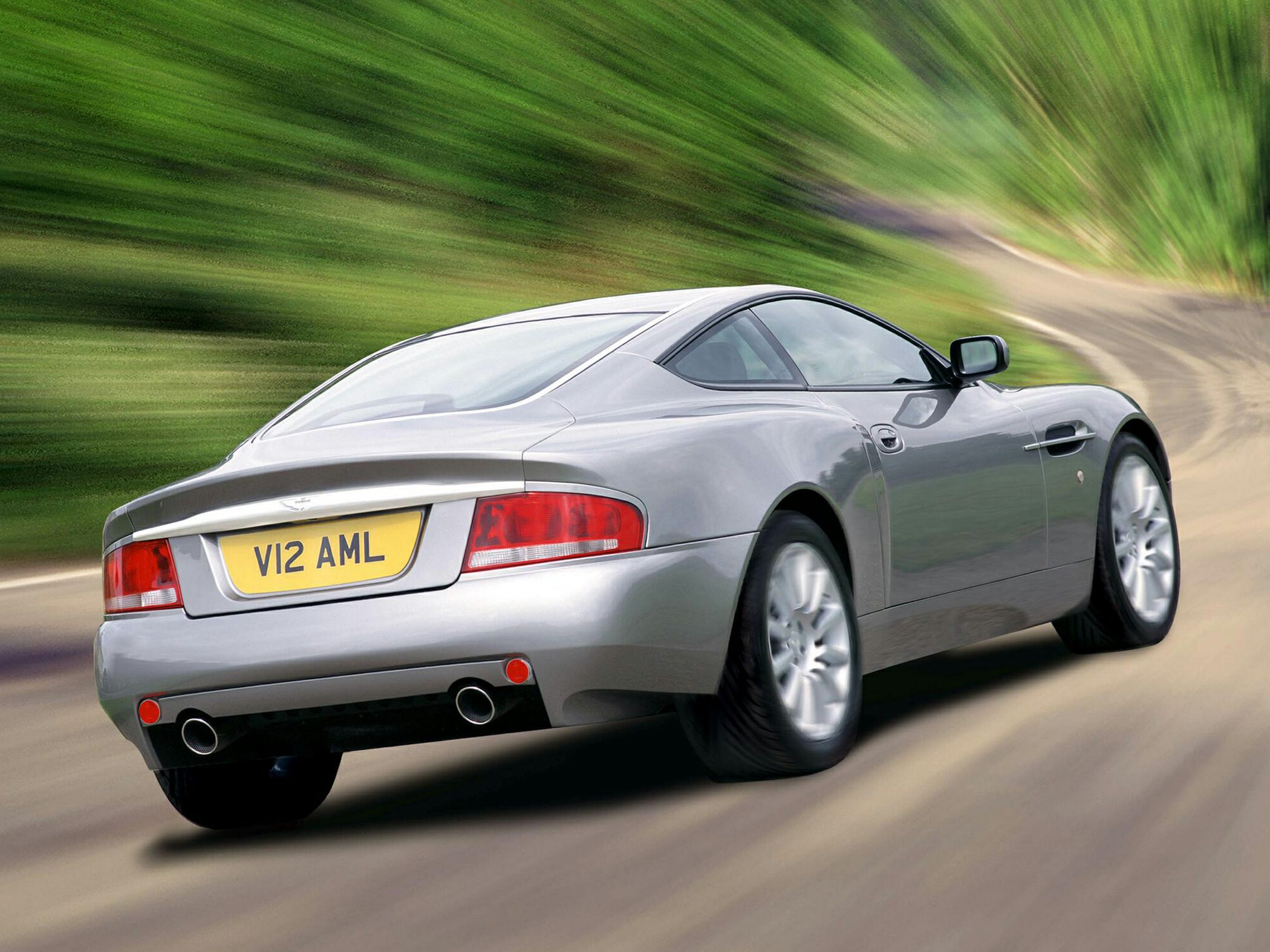 Rear three-quarter view with dual exhaust and sleek coupe lines