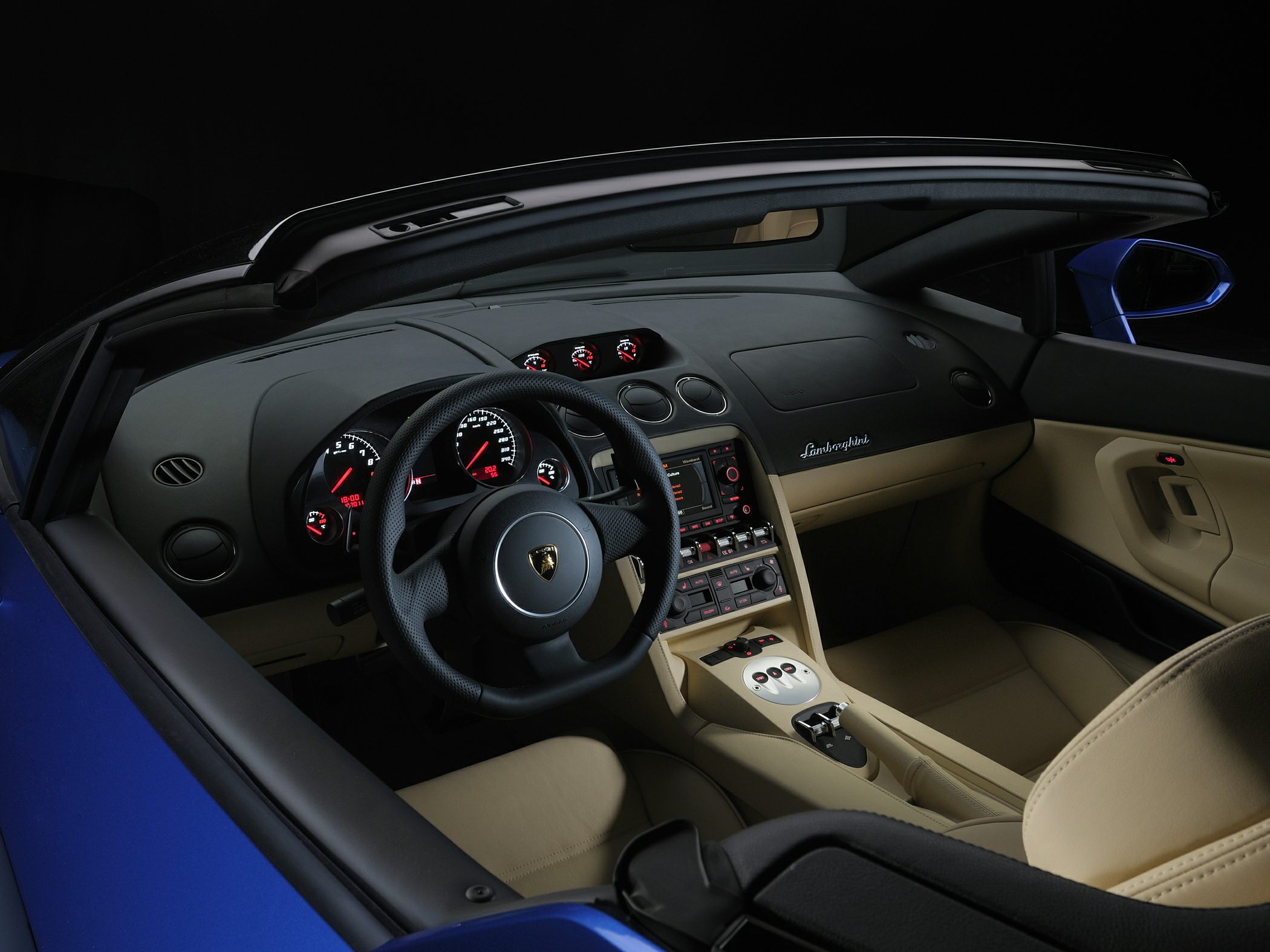 Sports car interior with steering wheel, dashboard, and center console