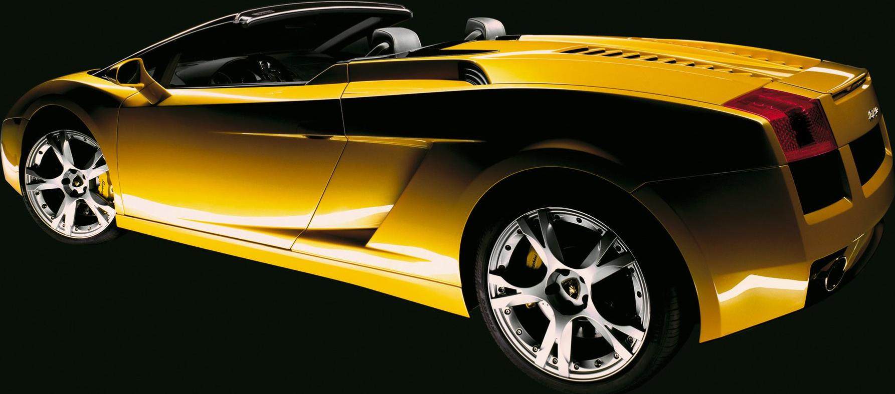 Yellow convertible sports car side view with distinctive alloy wheels.