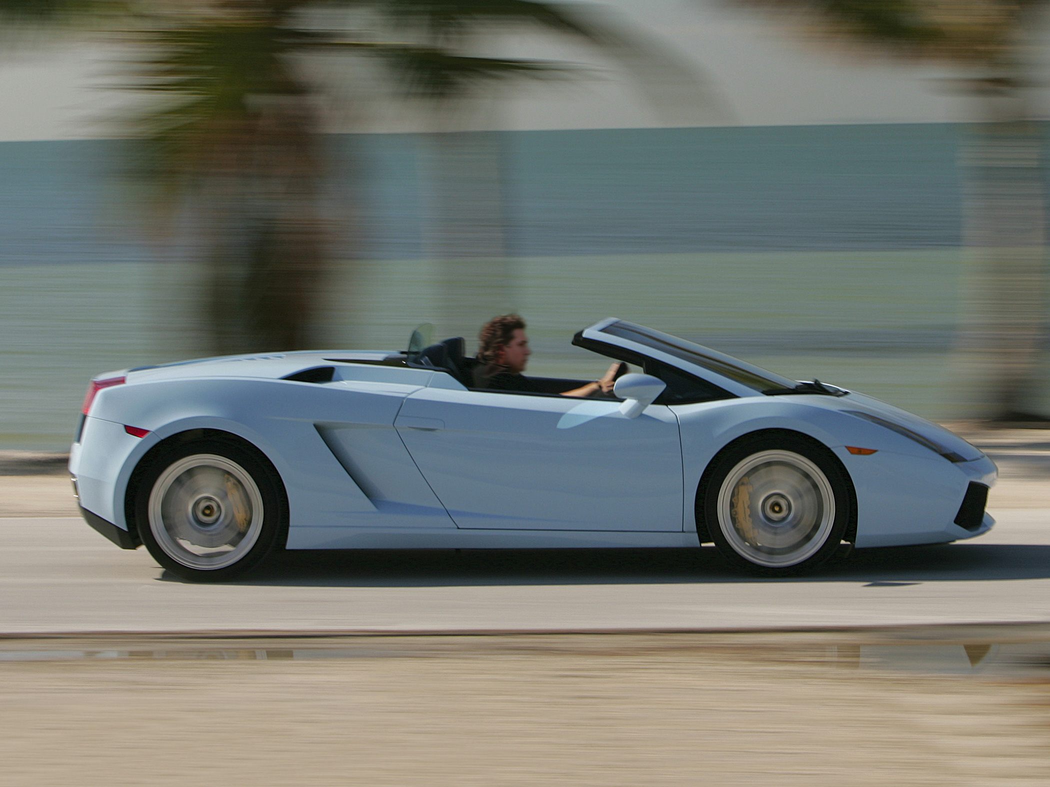 Side profile of convertible sports car with open roof and sleek design