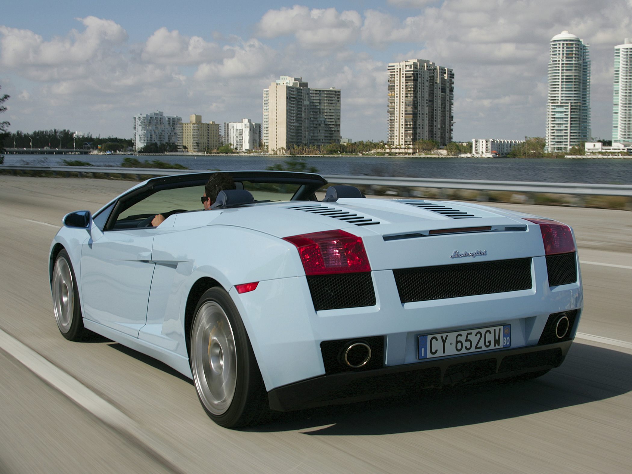 Rear view of a convertible sports car with distinctive taillights in motion