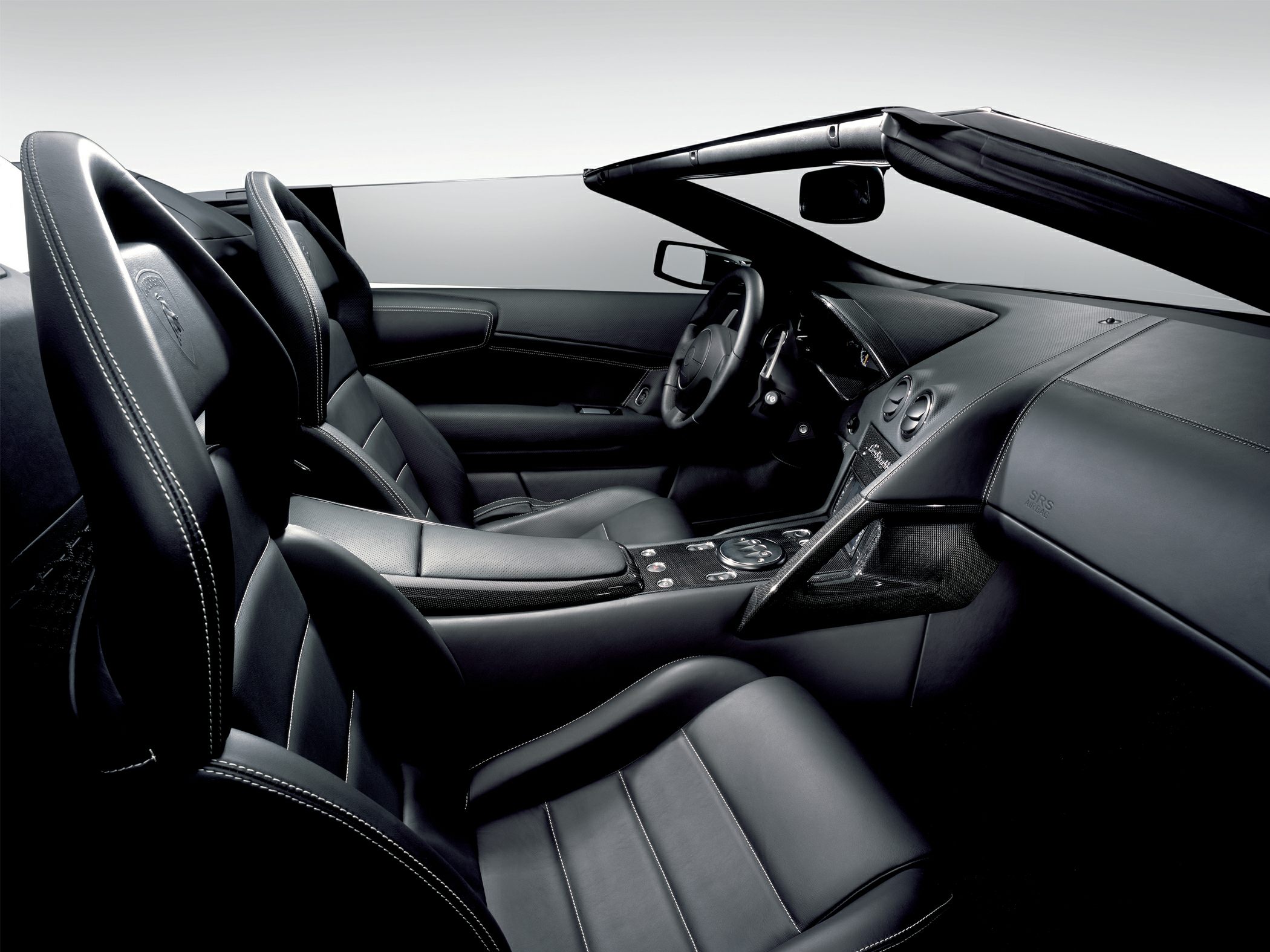 Black leather sport seats with detailed stitching and sleek dashboard