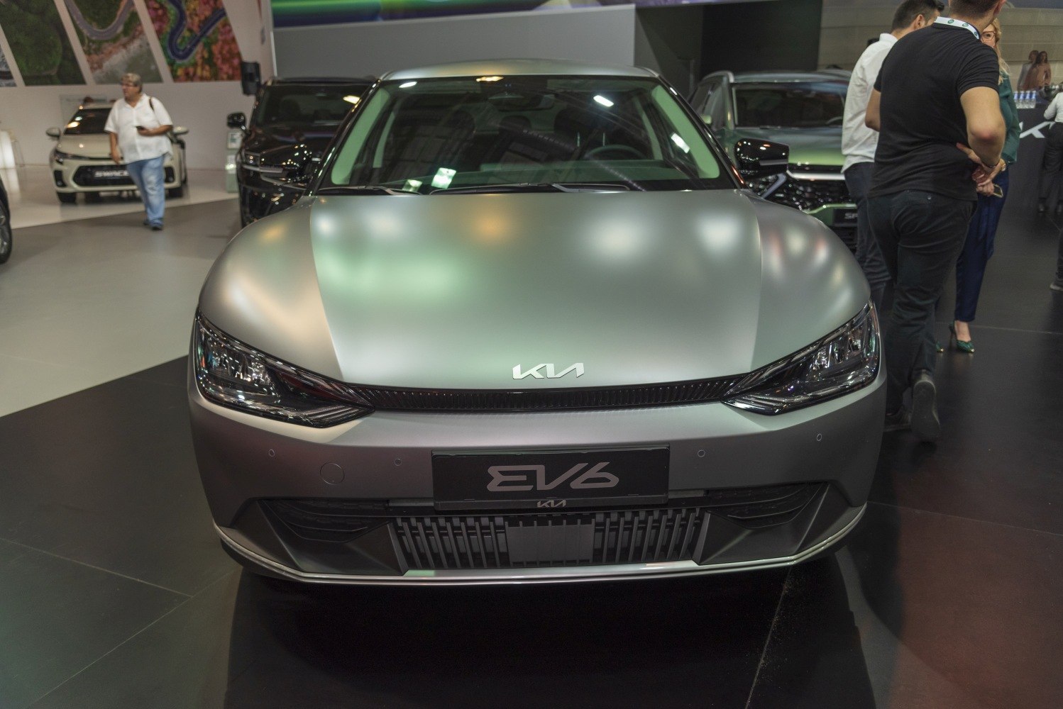 Front view with LED headlights and smooth electric car hood.