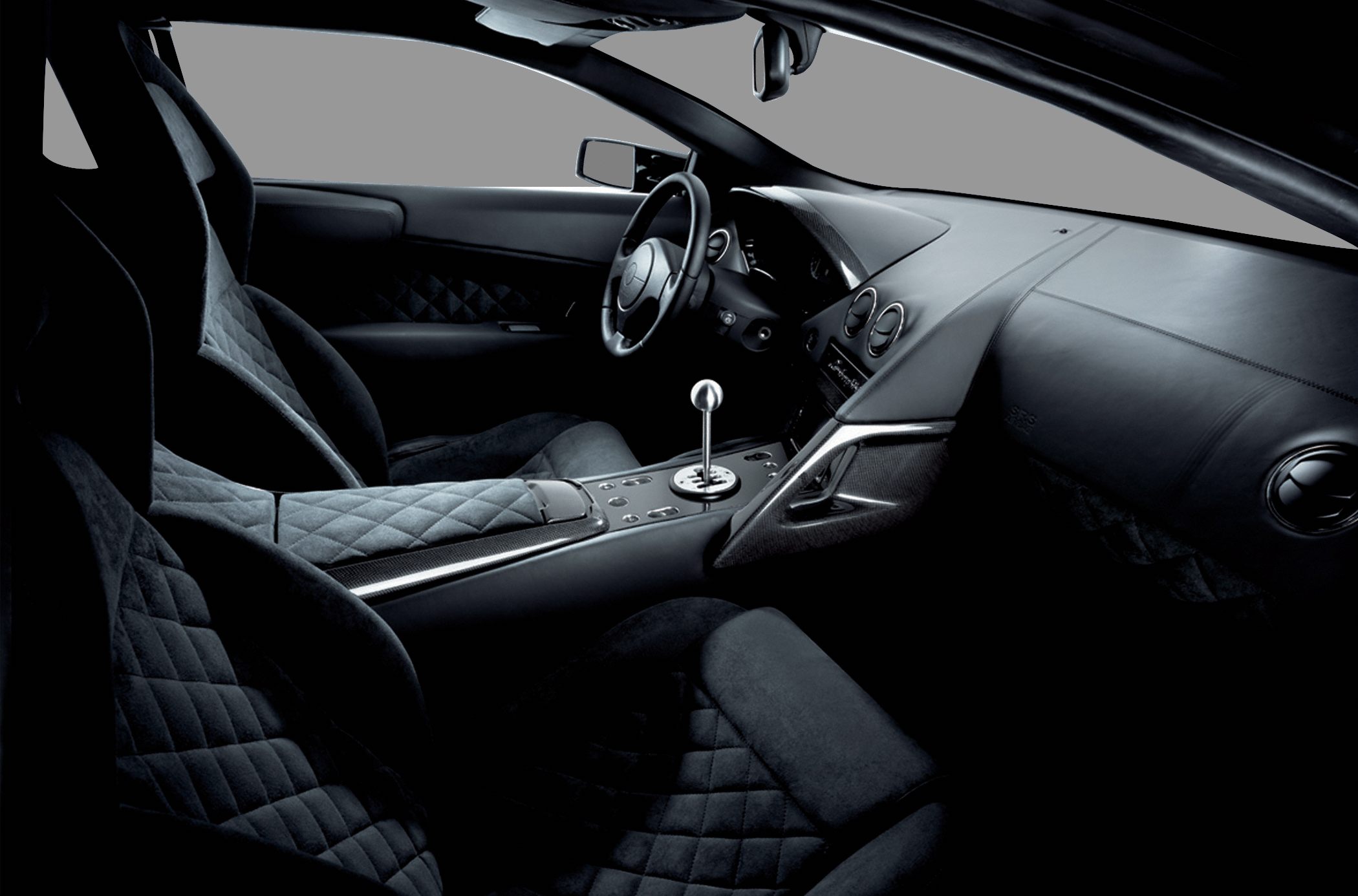 Quilted seats and gated manual gear stick in a luxury sports interior