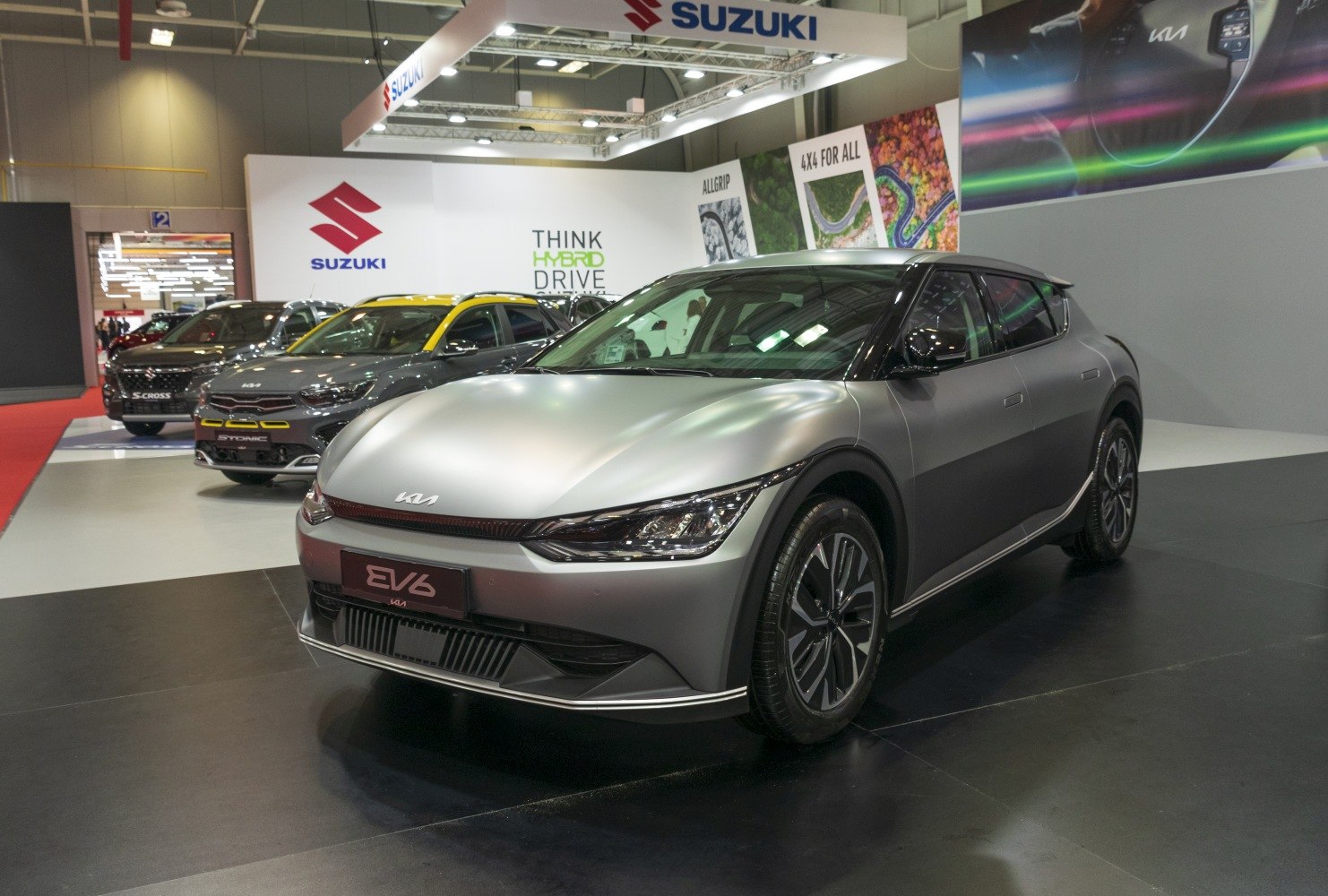 Front view of silver electric crossover with LED headlights and aerodynamic shape