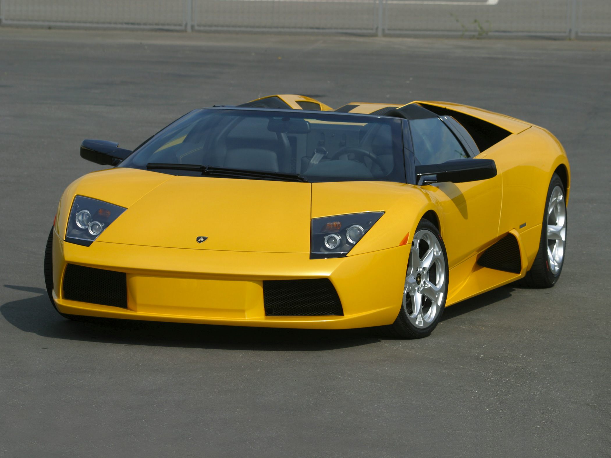 Yellow convertible with angular headlights and sporty aerodynamic body