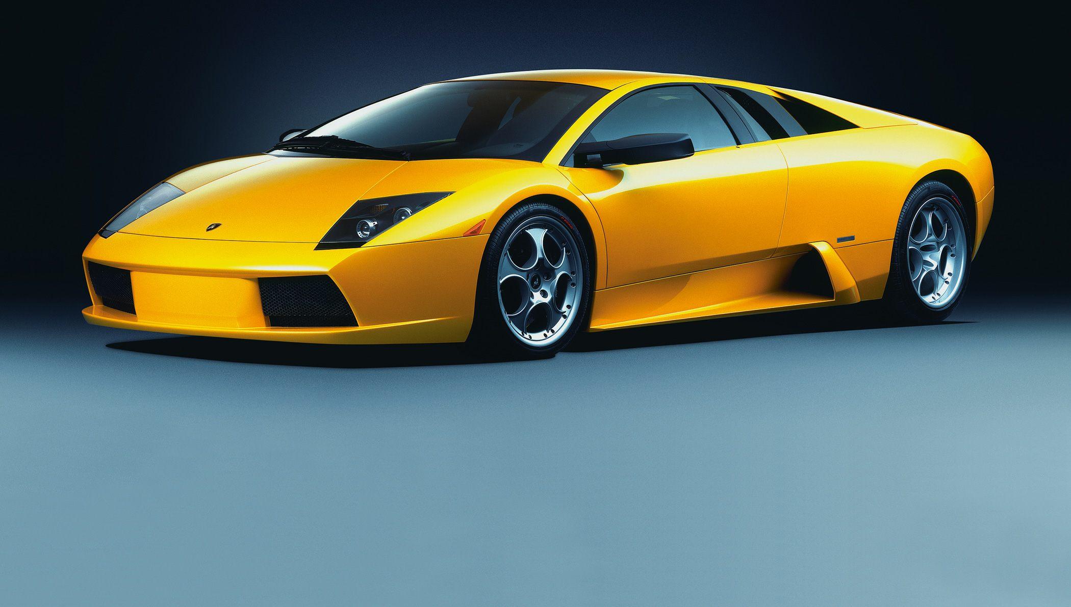 Yellow sports car front and side profile with alloy wheels