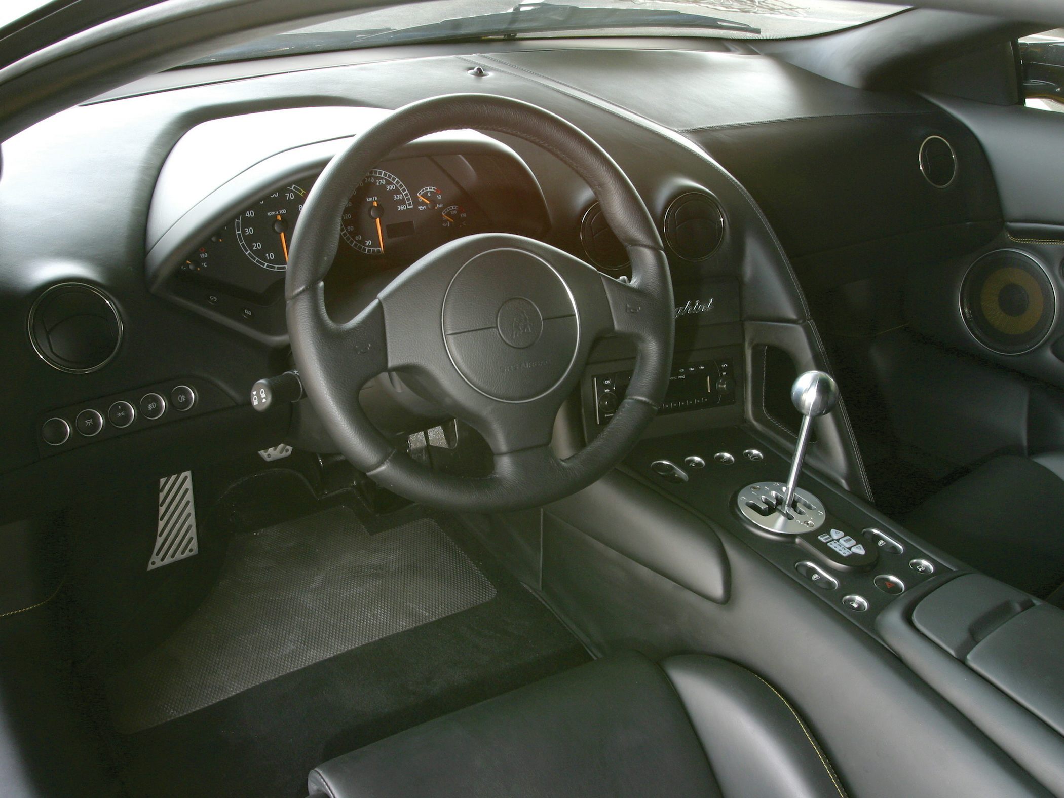 Gated metal gear shifter and sporty dashboard with instrument cluster