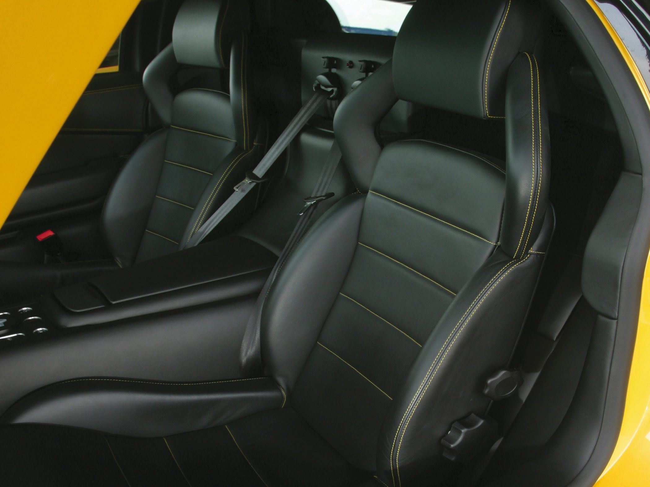 Black leather bucket seats with yellow stitching