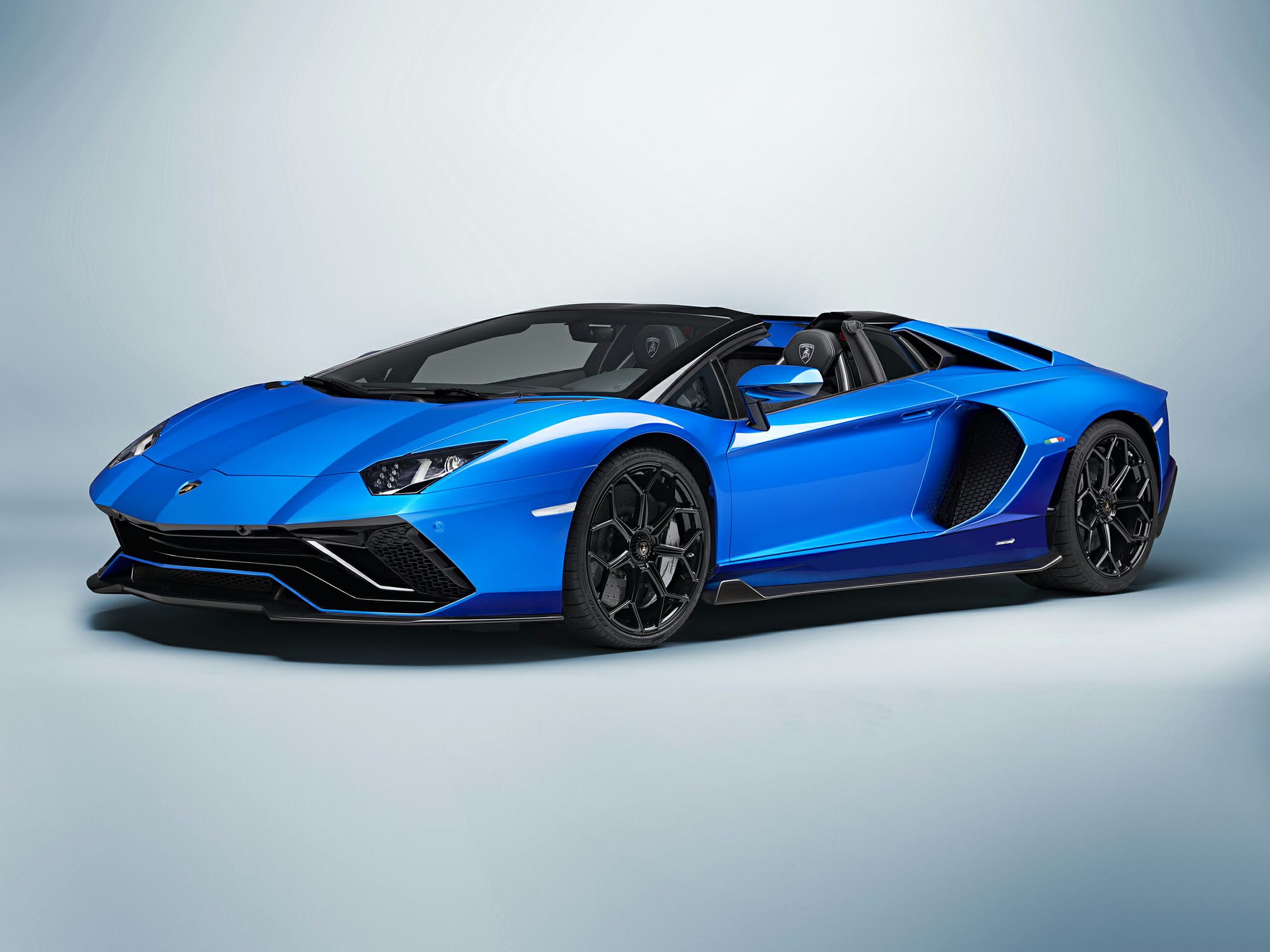 Blue open-top supercar with aggressive aerodynamic body and black wheels