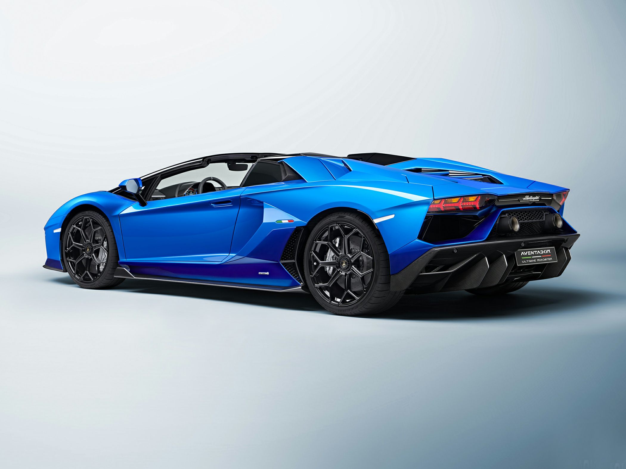 Blue convertible sports car with prominent rear design and black alloy wheels