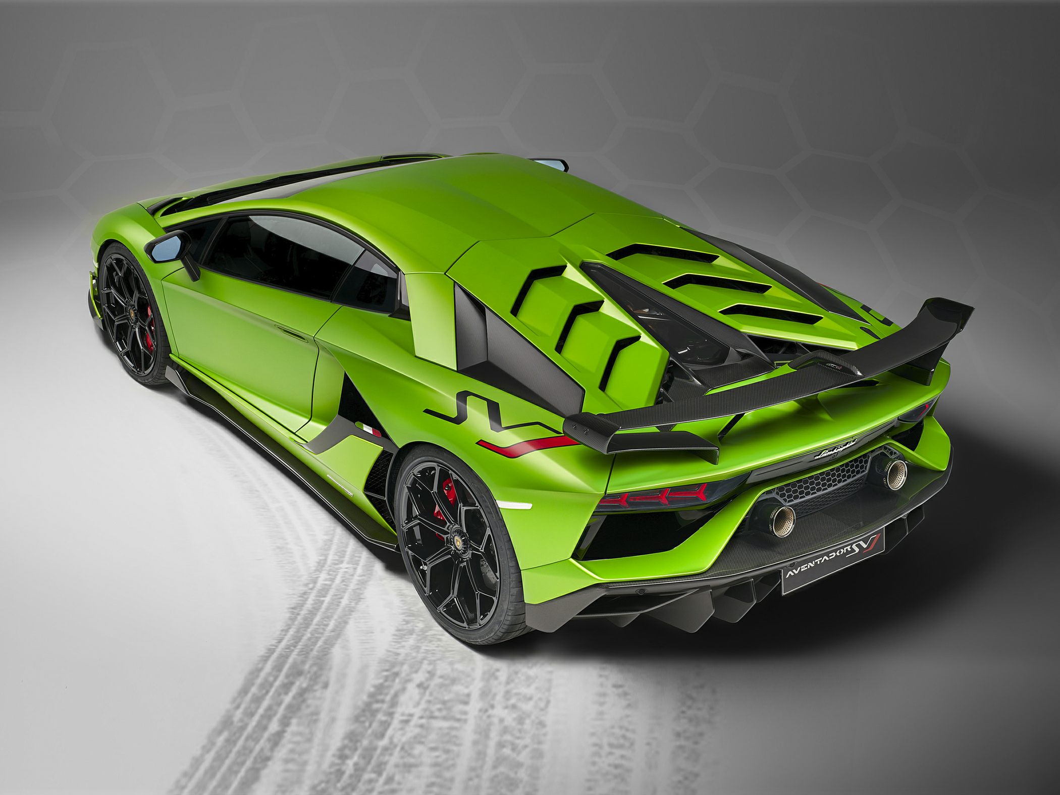 High-angle rear view of sports car showing aero elements and carbon fiber wing