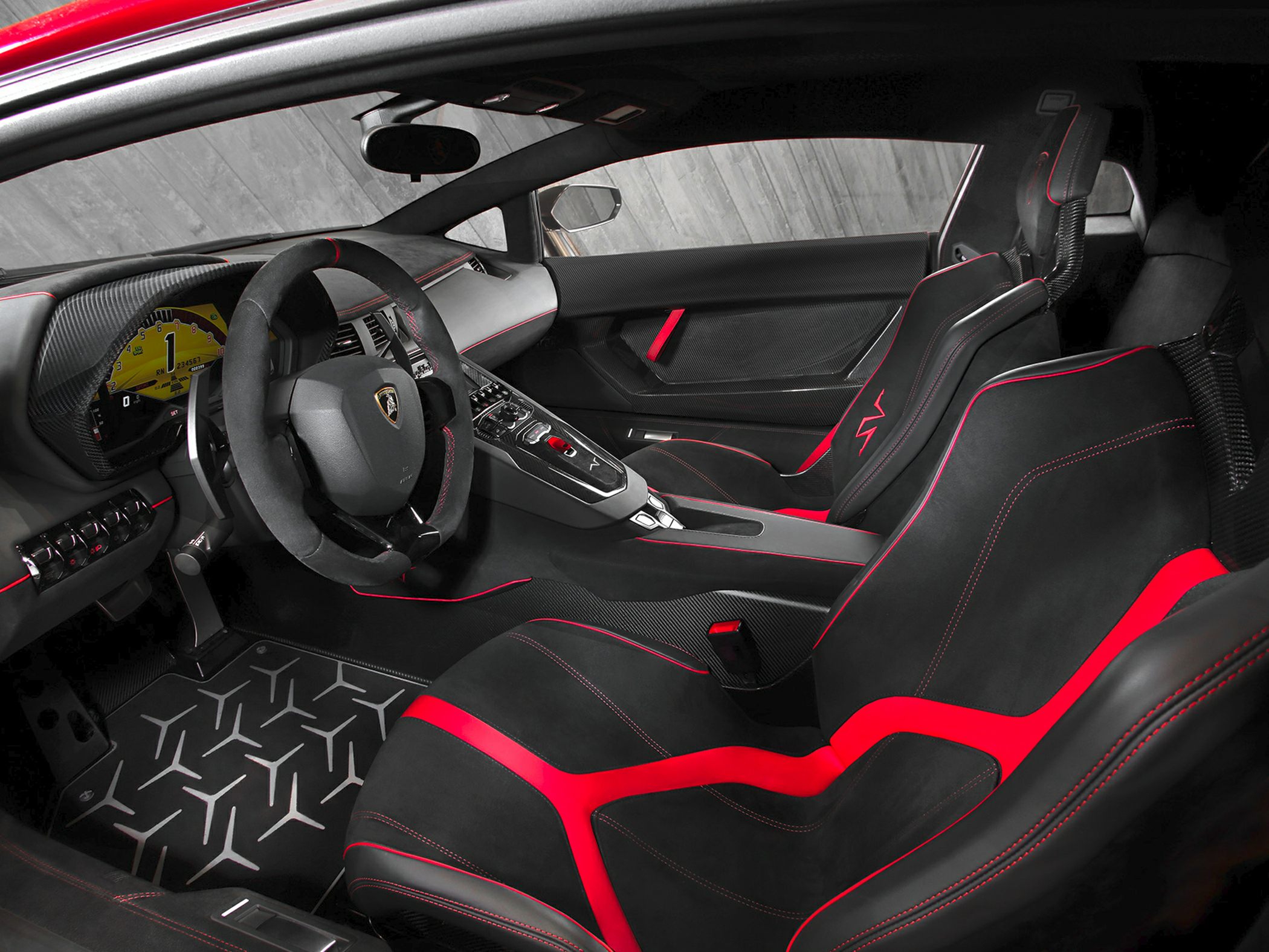 Sporty black and red racing seats with carbon fiber trim and detailed cockpit design