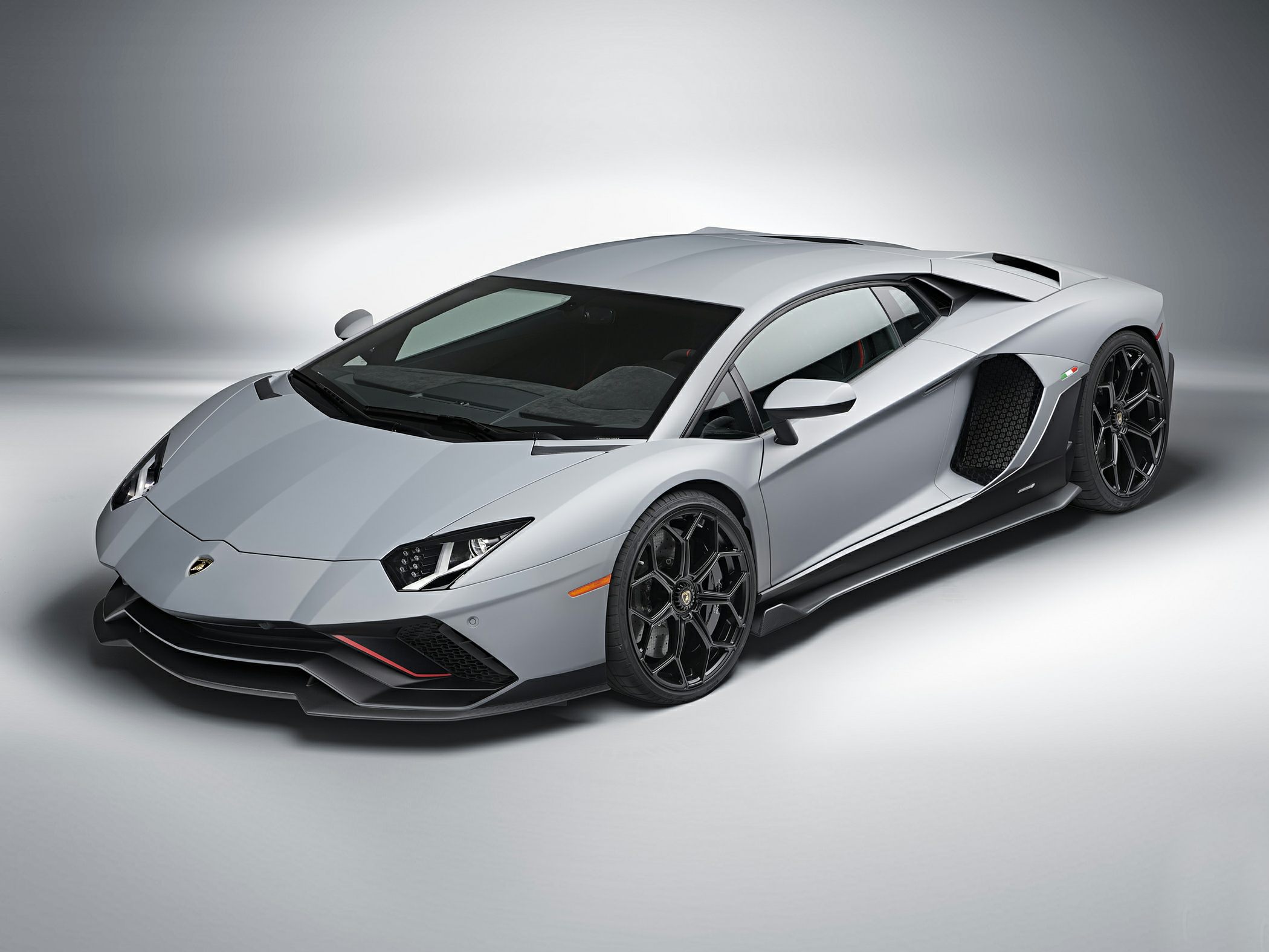 Silver sports coupe with angular front and aerodynamic side air intakes