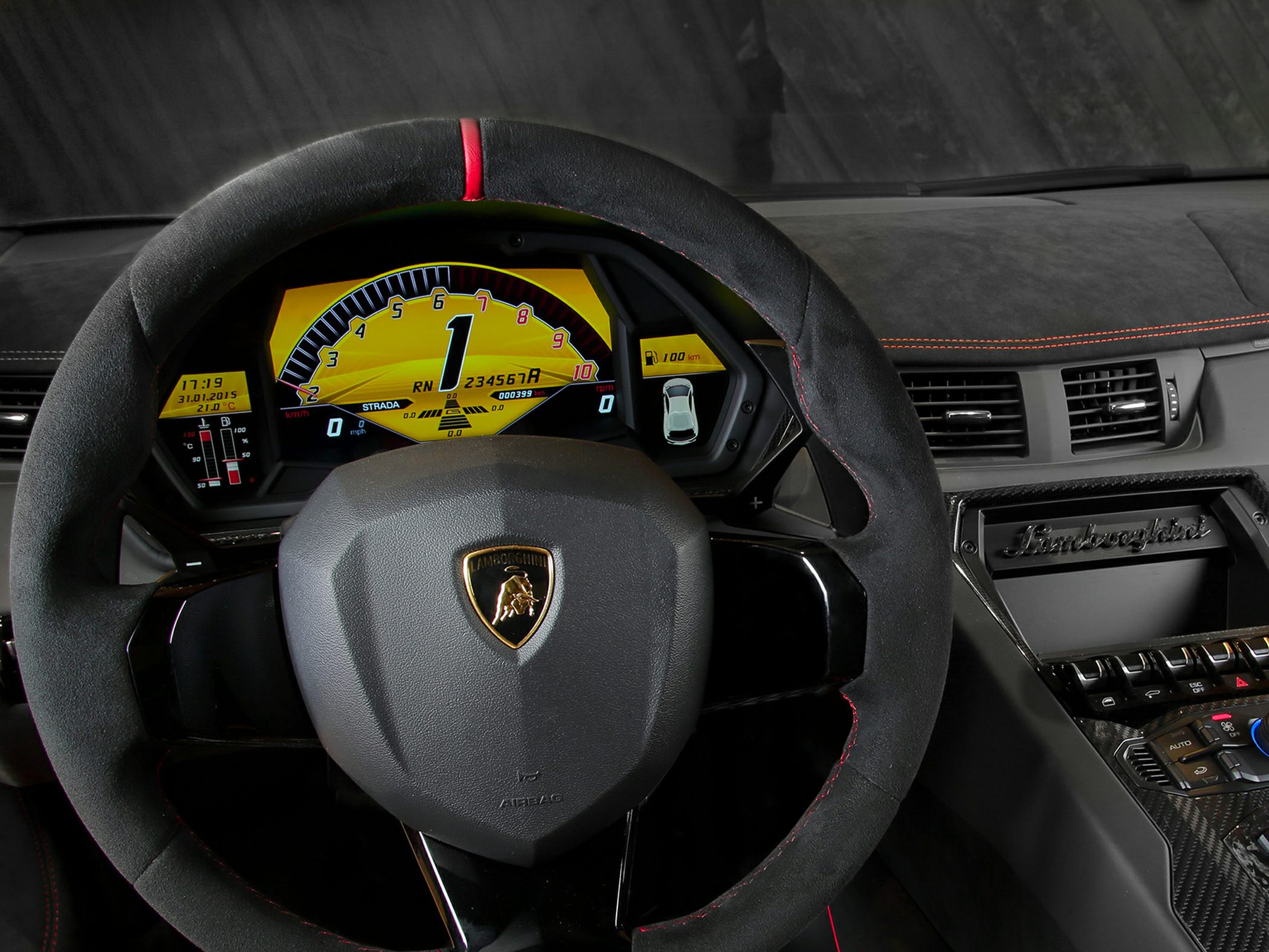 Digital instrument cluster and Alcantara steering wheel with red stripe.