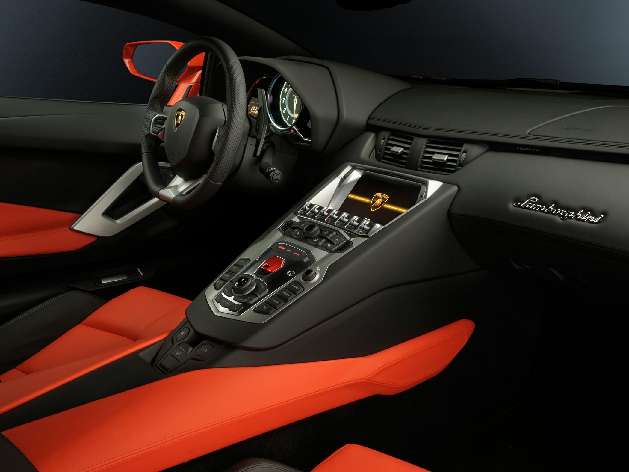 Luxury sportscar dashboard and center console with red leather seats