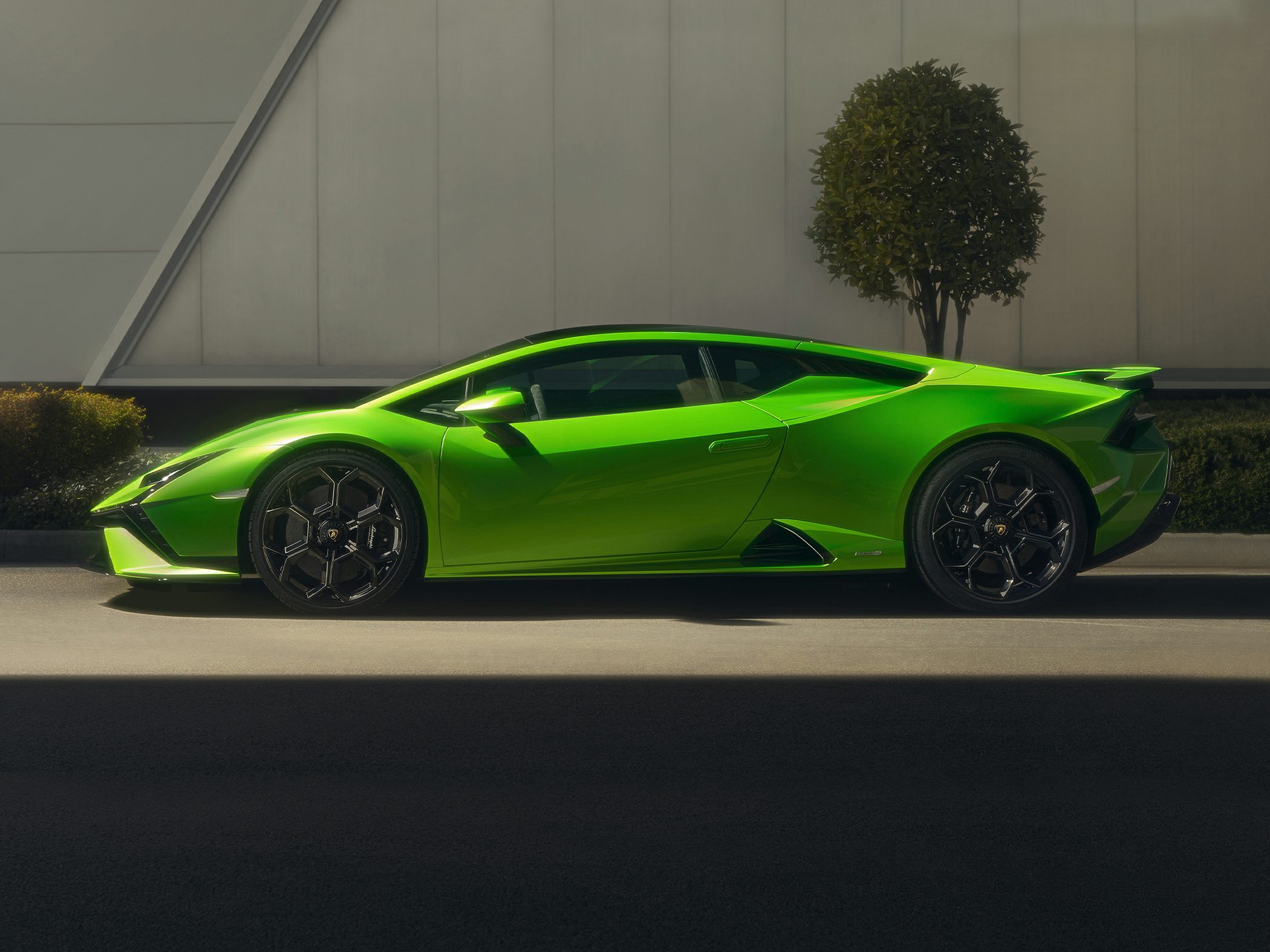 Side profile view and hexagonal black alloy wheels of a sports coupe