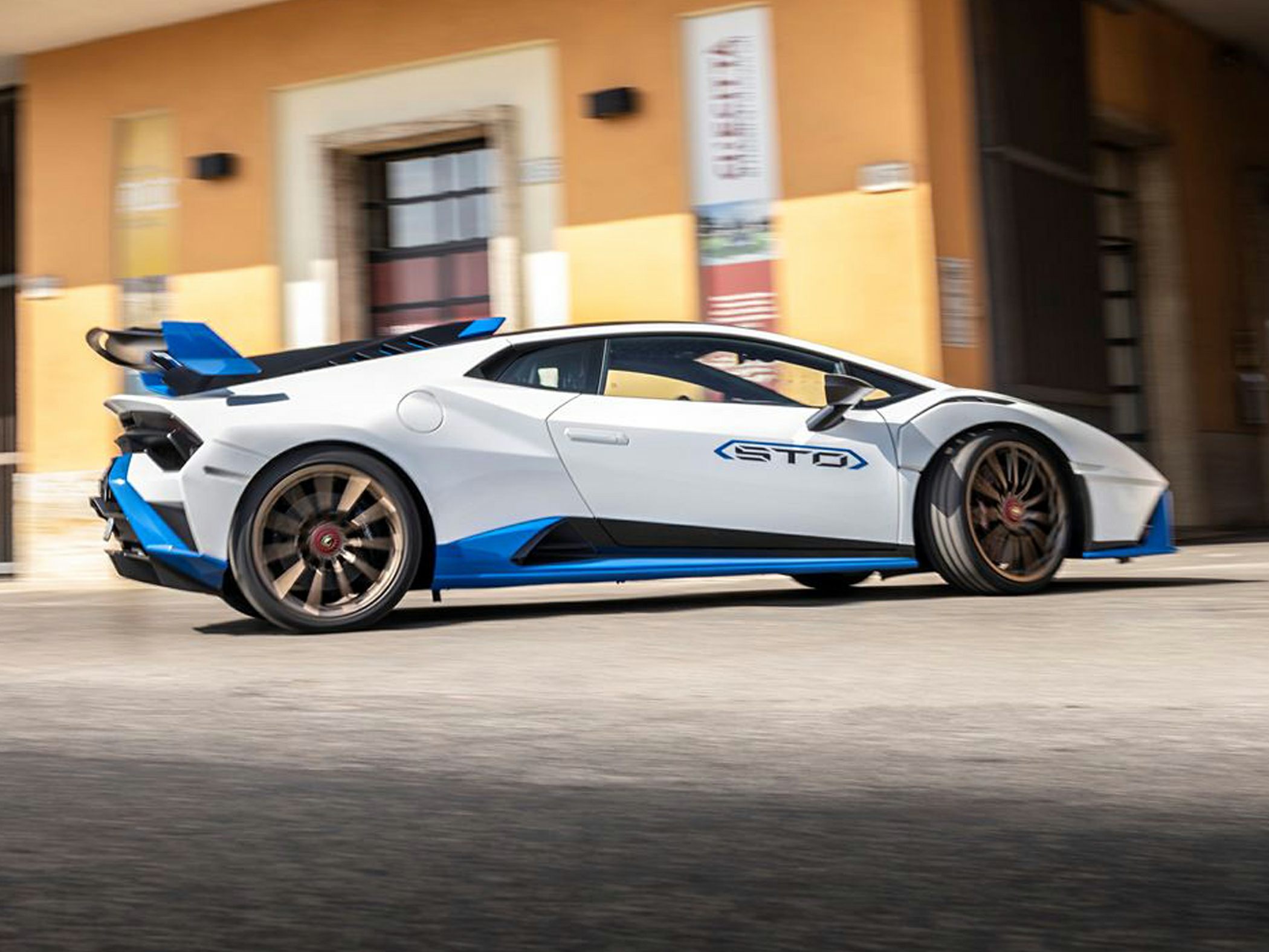Side profile of Lamborghini Huracan STO with large rear wing and sporty wheels