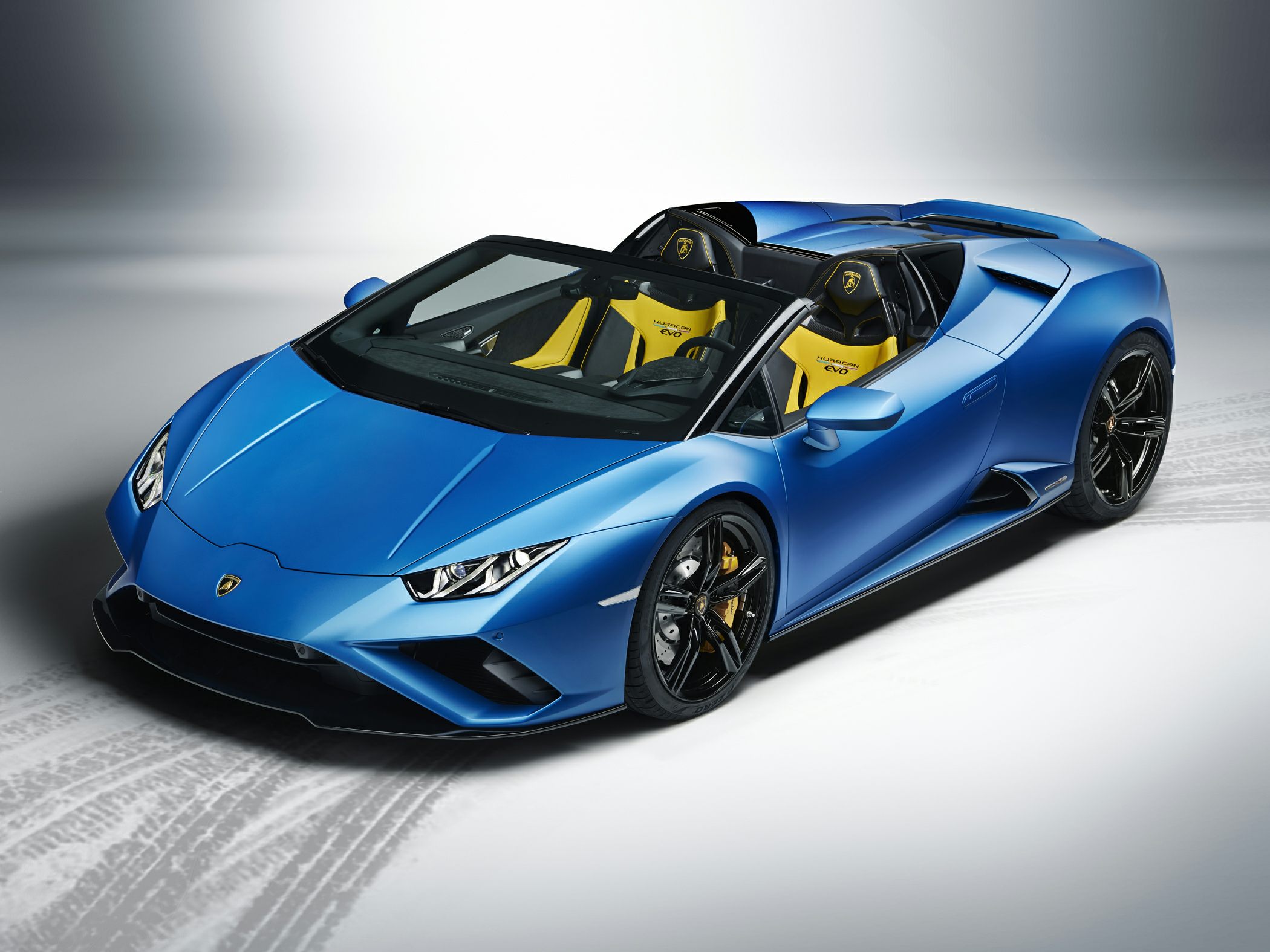 Blue convertible sports car with yellow sport seats and black wheels