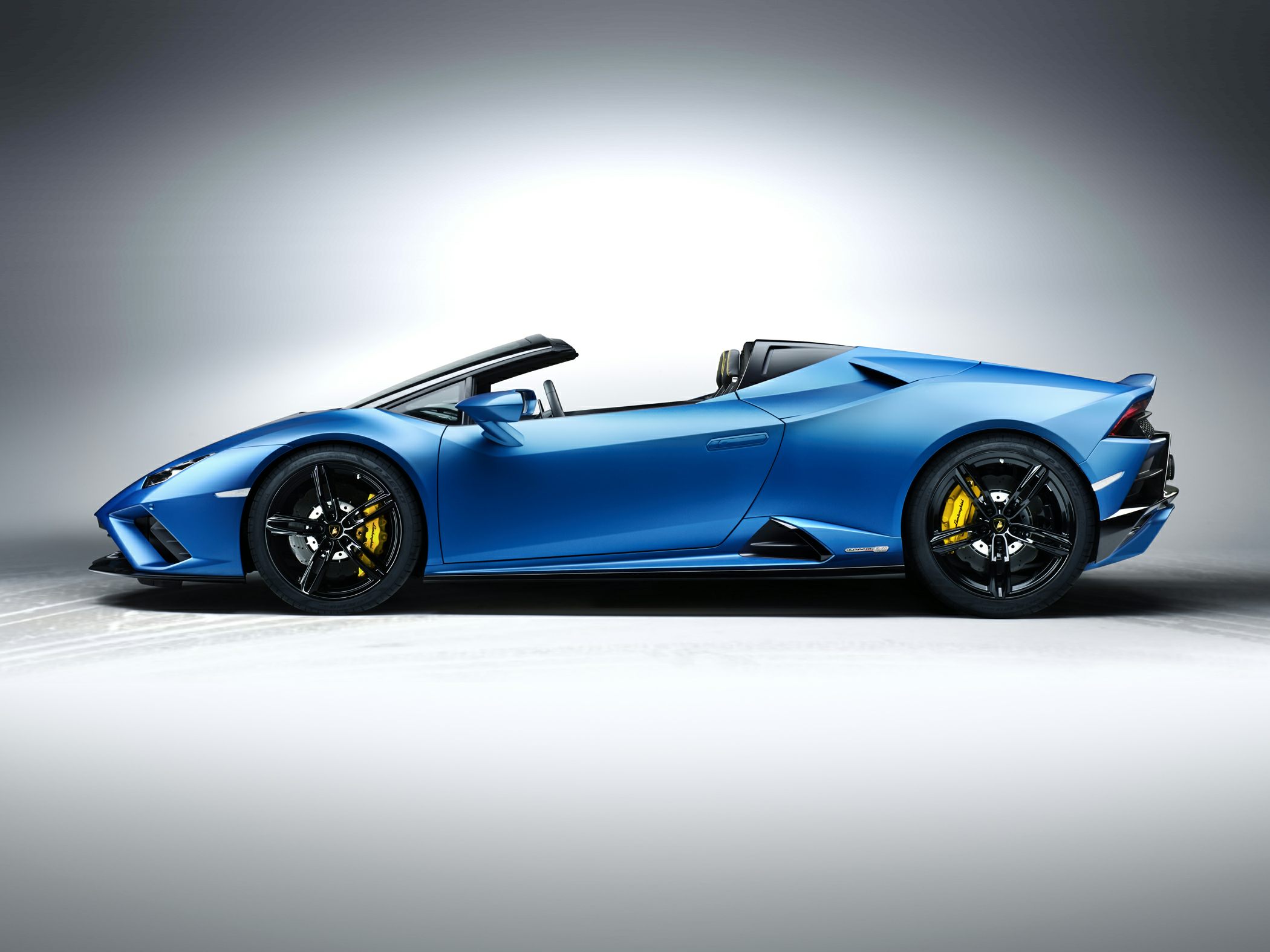 Side profile of a sleek convertible supercar with sporty wheels