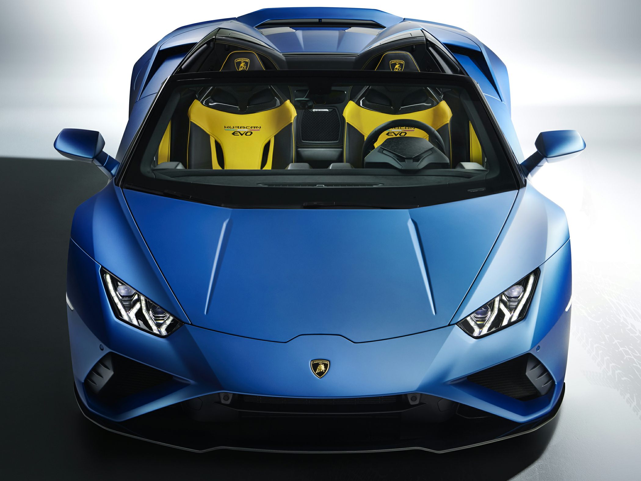 Front view of convertible with sharp headlights and yellow sports seats