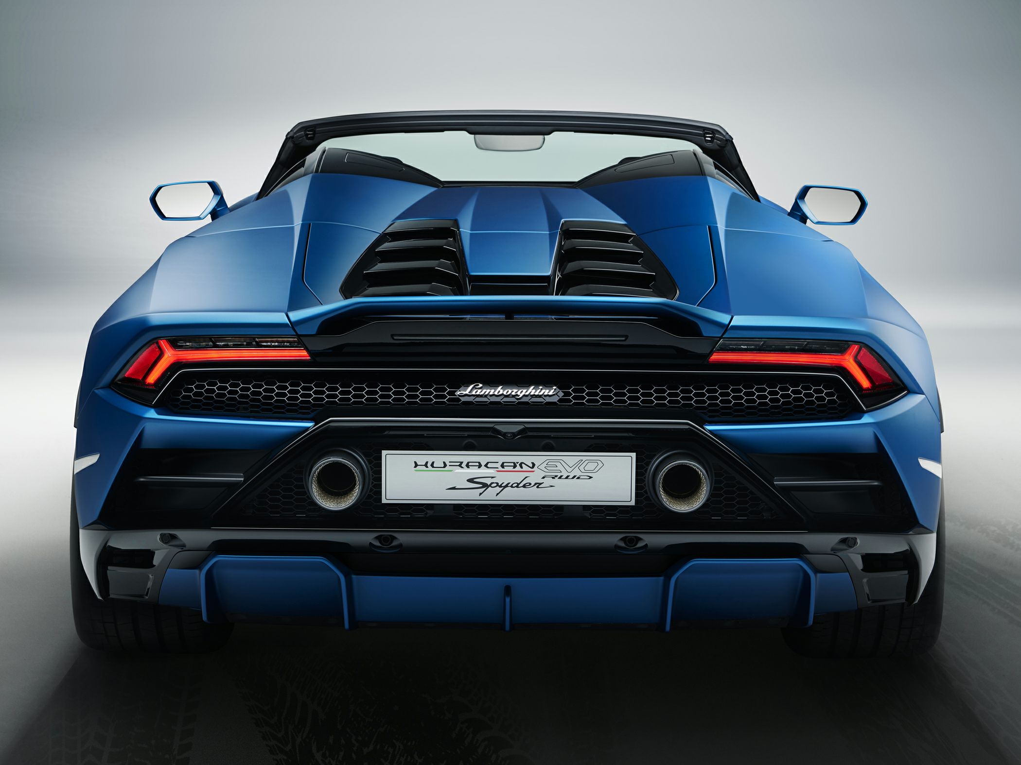 Rear view with taillights, dual exhausts, and aerodynamic design