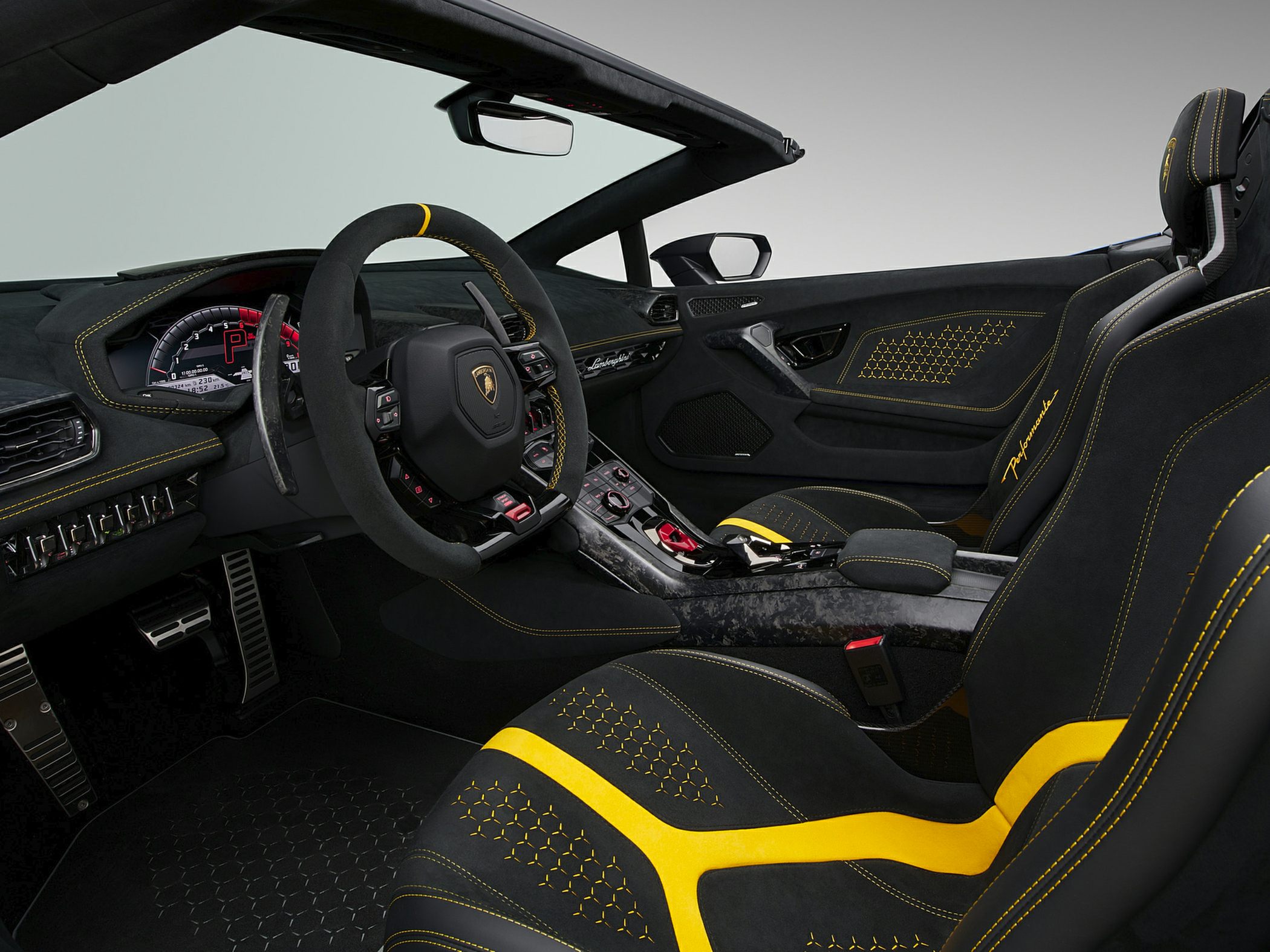 Luxury sports car interior with yellow-accented seats and advanced dashboard design