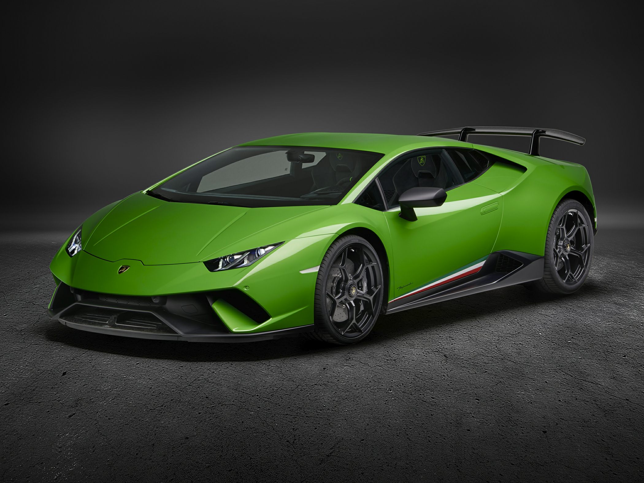 Green sports car with sharp angular design and prominent rear wing