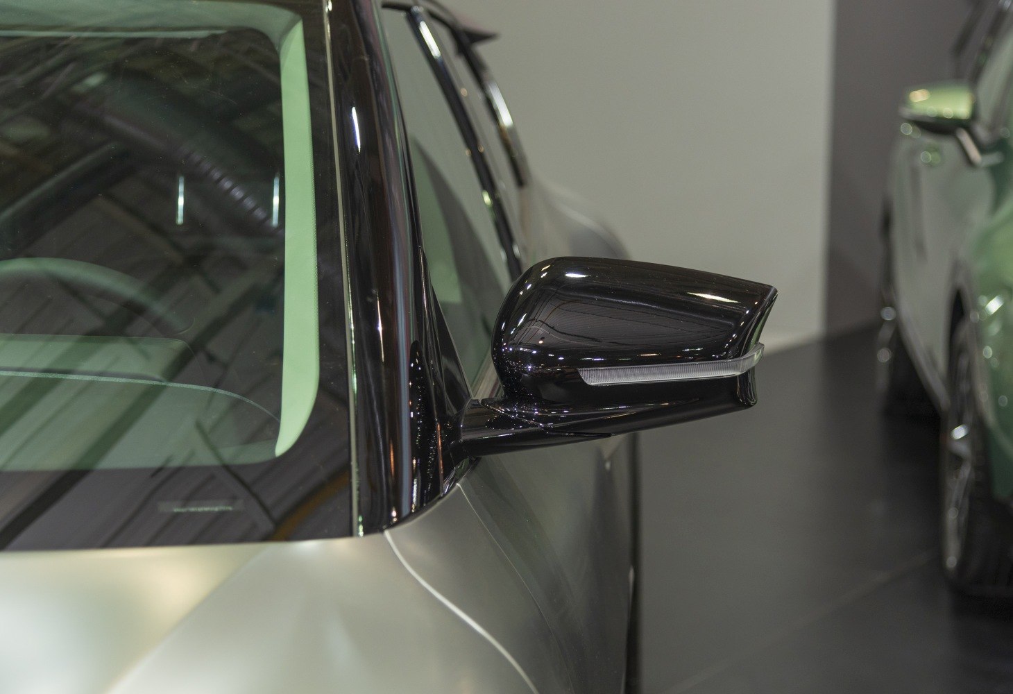 Close-up of sleek black side mirror with indicator light