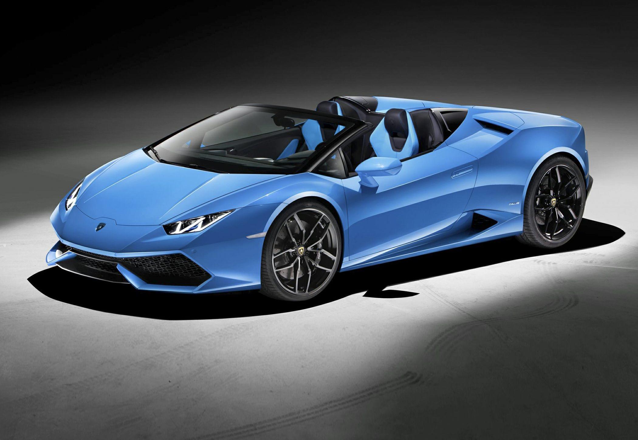 Blue convertible sports car with sleek front design and black rims