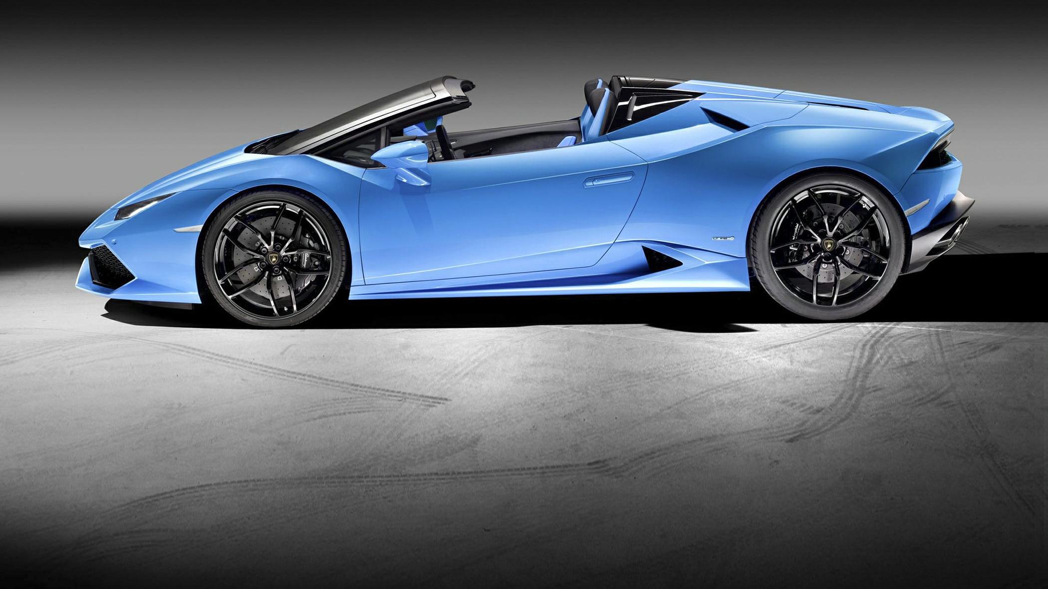 Blue convertible sports car side profile with aerodynamic design and open roof