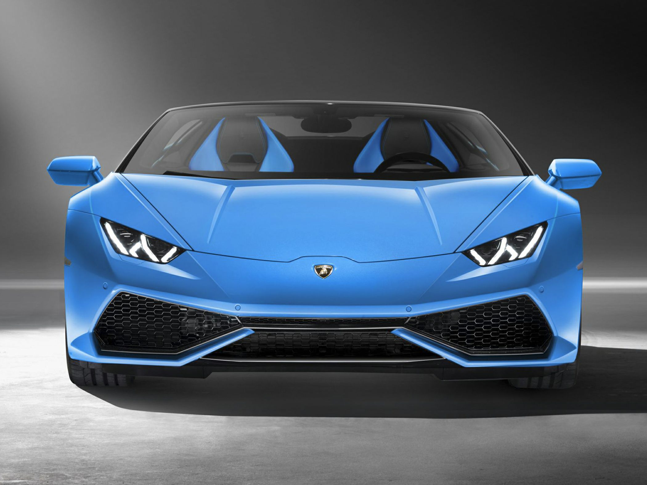 Front view with sharp headlights and sculpted front bumper